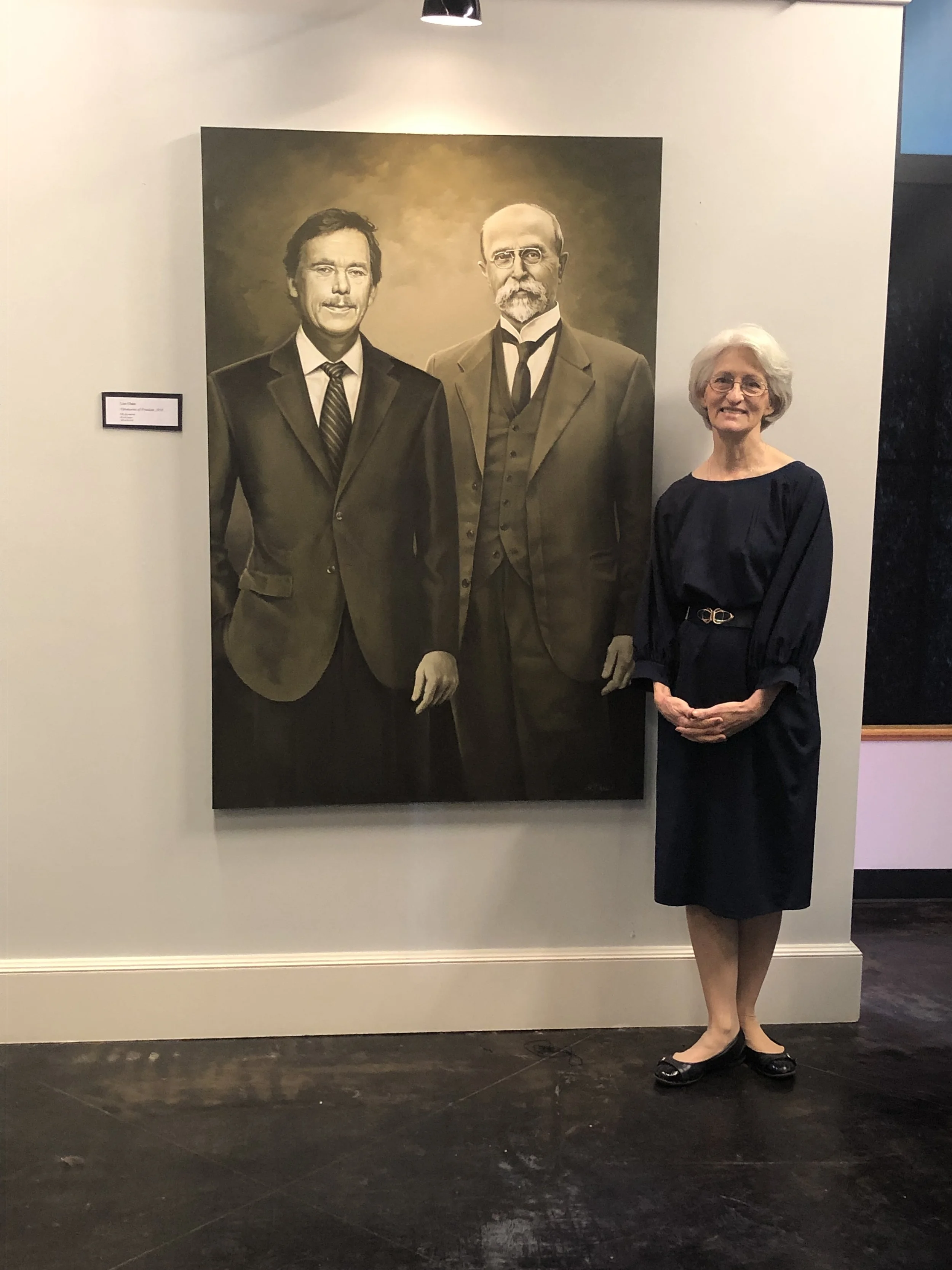Artist Lisa Chase with her painting, Visionaries of Freedom at the Czech Heritage Museum in Temple, Texas.