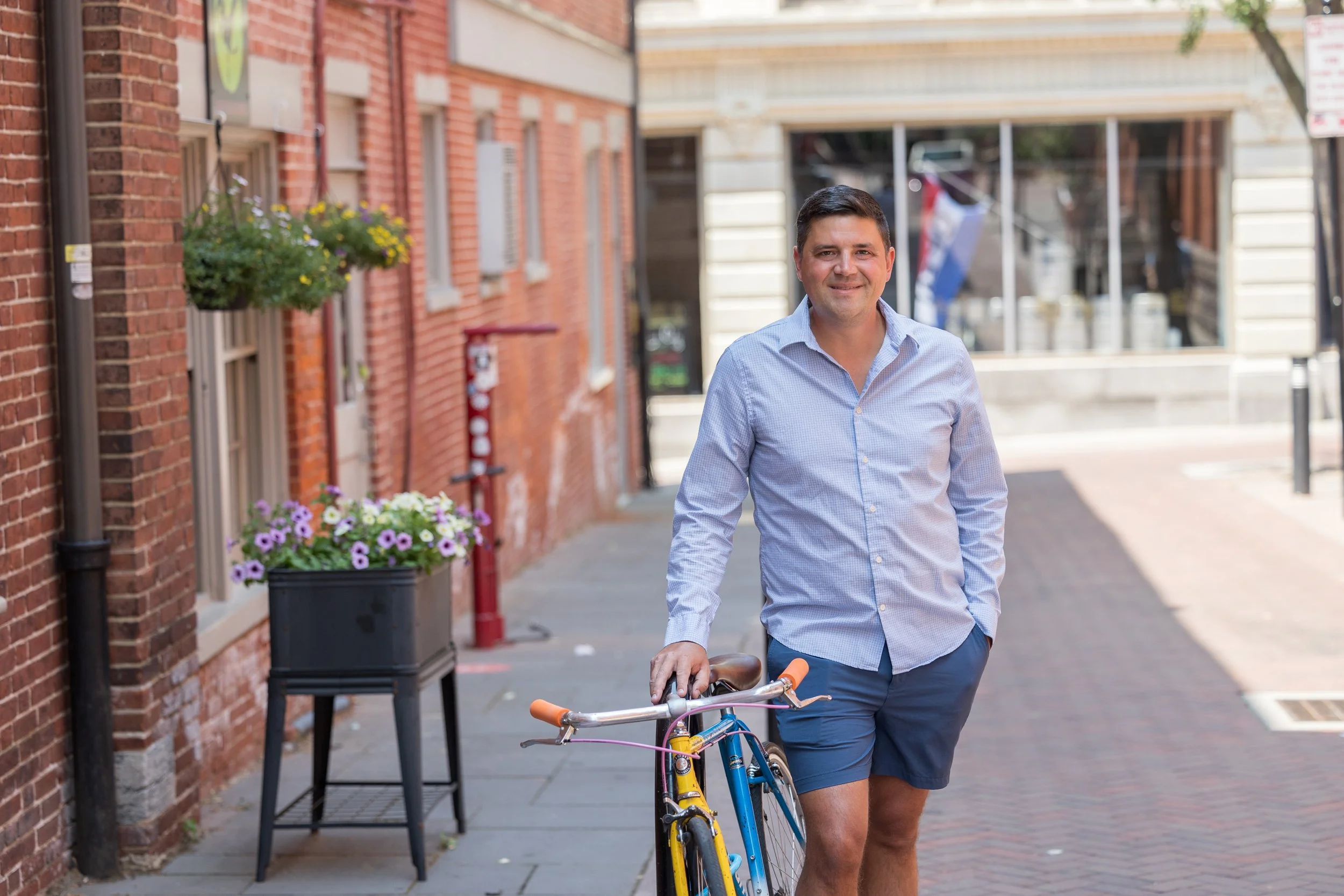 man standing by bike in market alley of Lancaster Central Market downtown Lancaster PA
