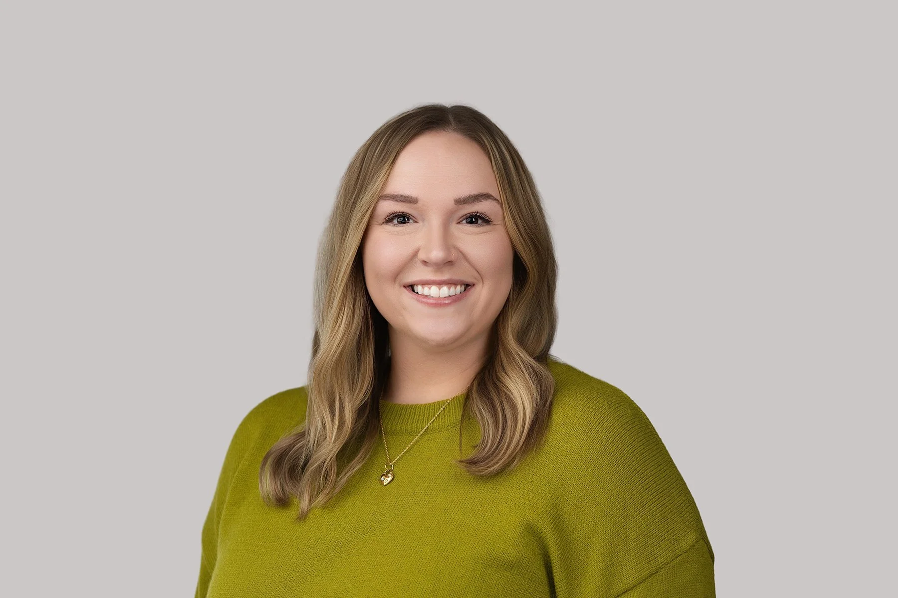 headshot portrait of woman in green shirt