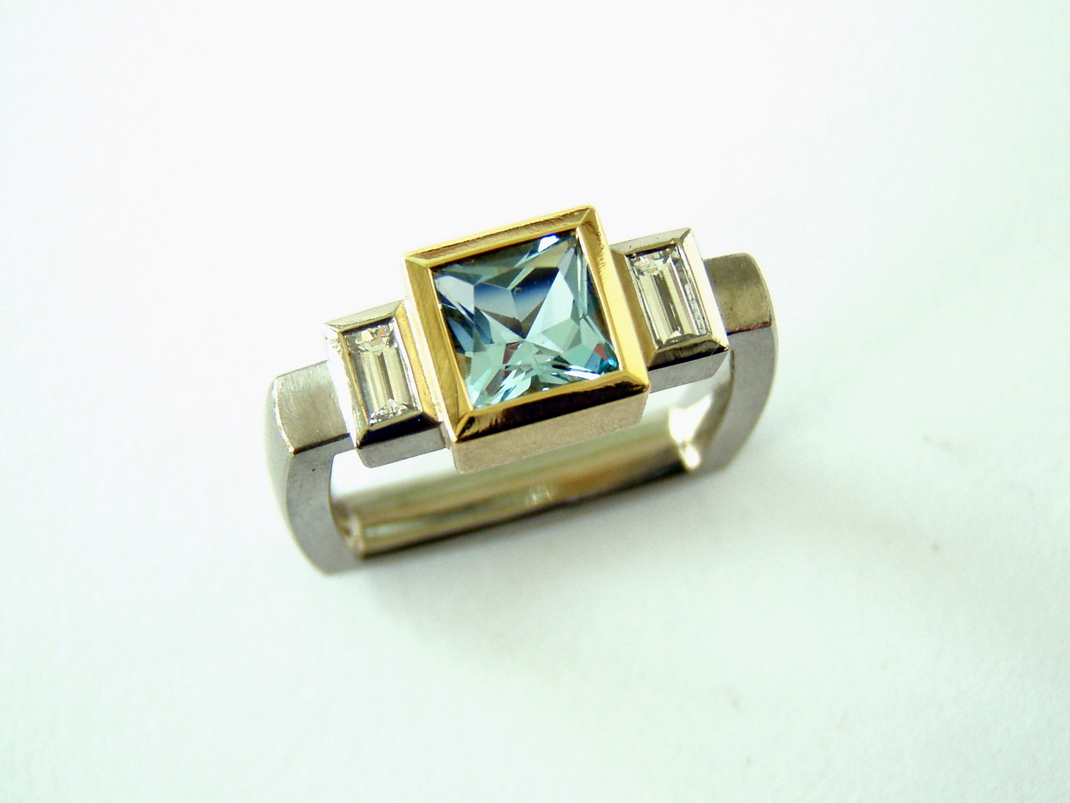  18ct white and yellow square engagement ring set with large princess cut aquamarine and two baguette diamonds 