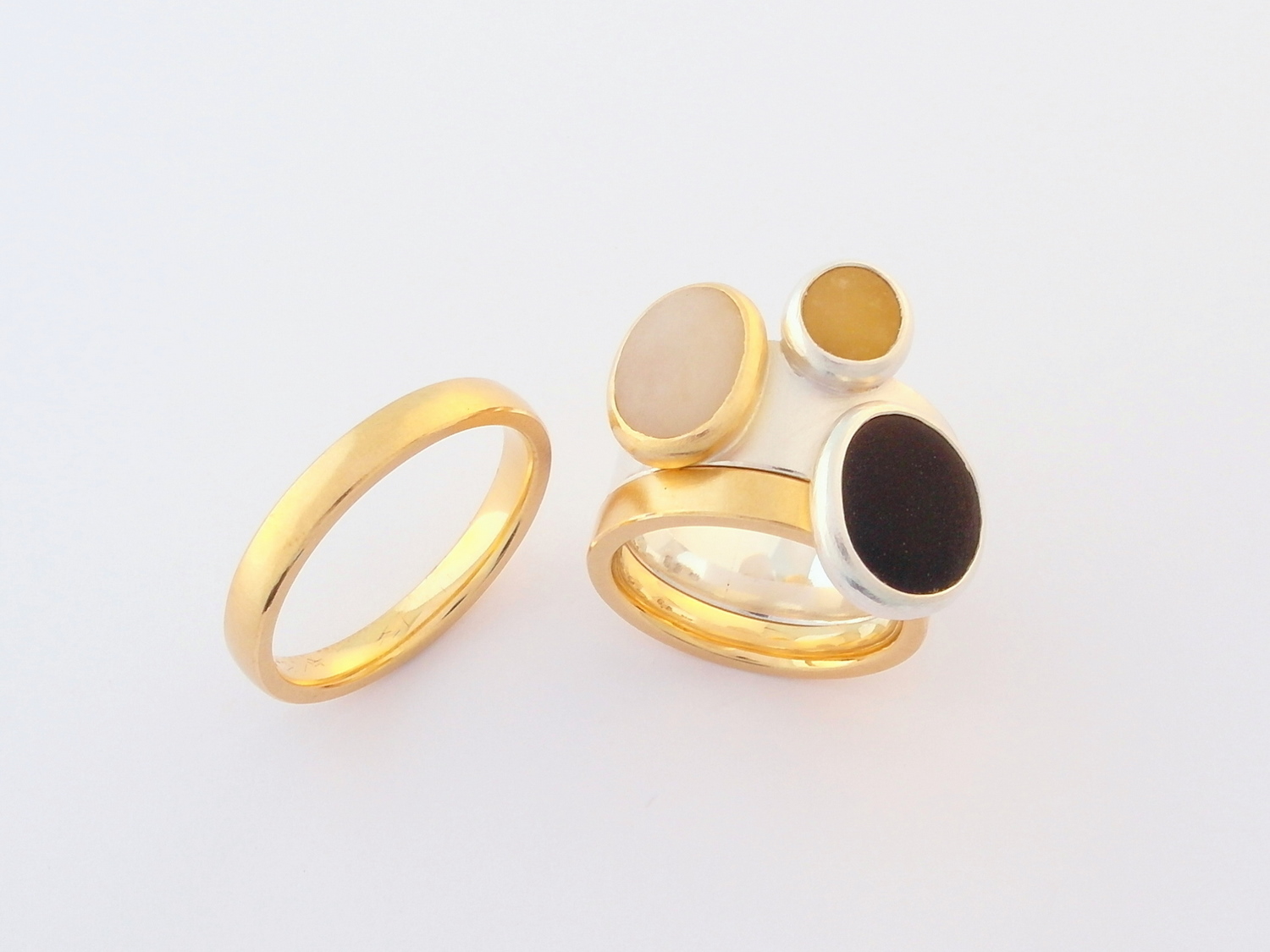  His and hers wedding and engagement rings in 18ct yellow gold and silver set with naturally coloured beach pebbles 