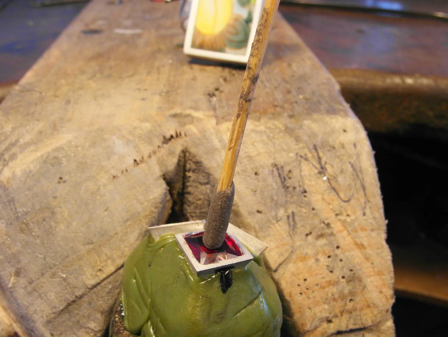  Snip off the point on a tooth-pick and use blue tack to handle the stone, the remaining pointy end can be used to push and rock the stone to check its seat prior to setting. Also mark the stone and setting at this stage with a permanent marker to no