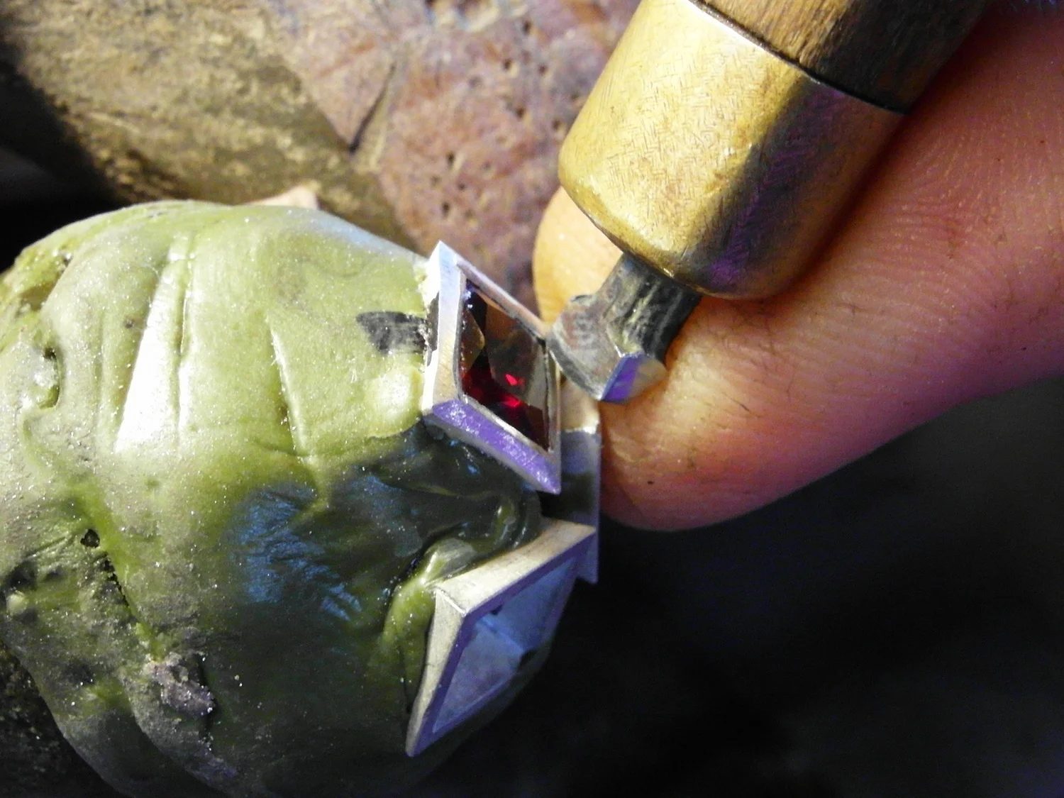  Finally with the hand setter you can come right in, very steeply making sure that the metal comes right down onto the stone, fully securing it. 