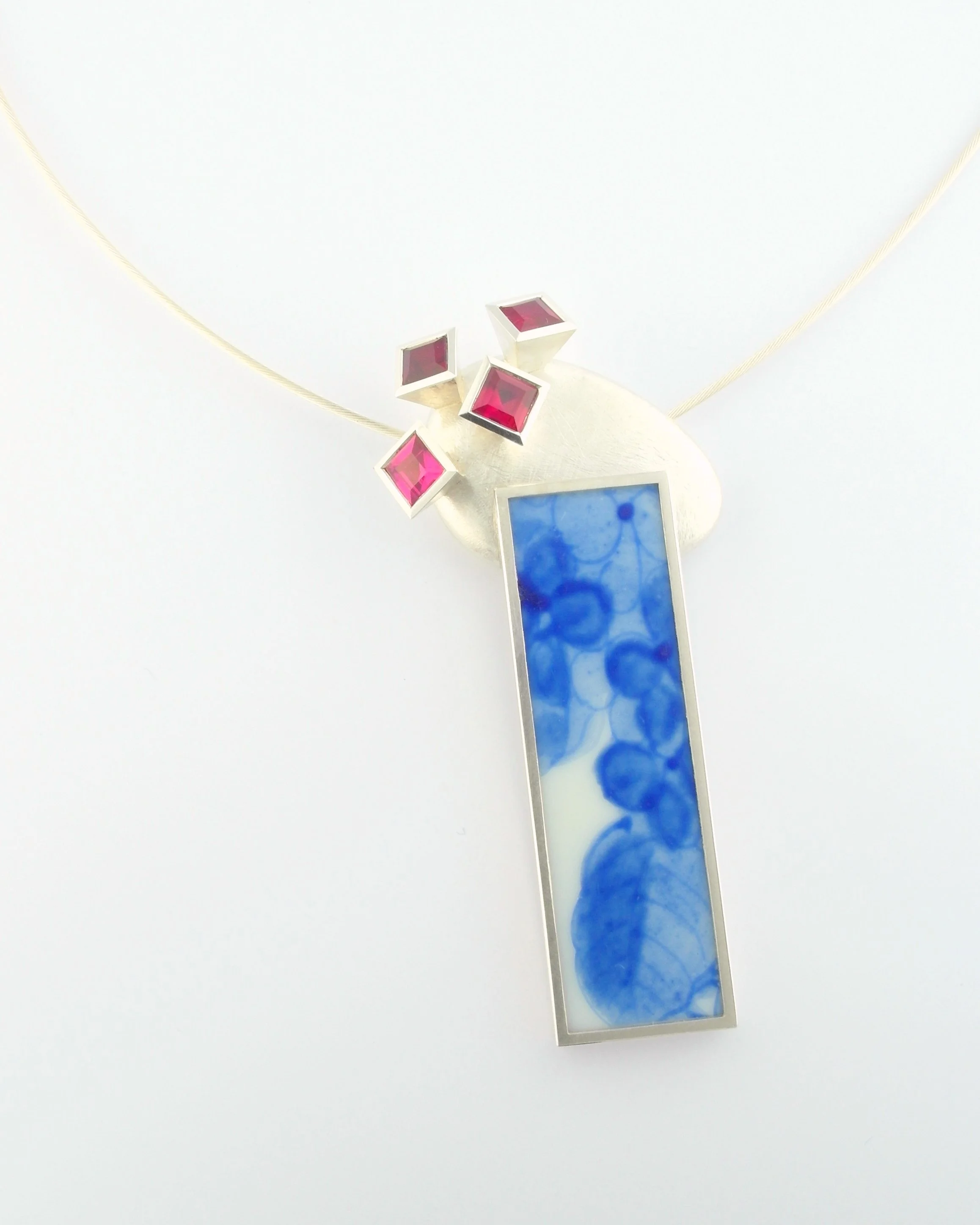 Silver, reclaimed ceramic, synthetic rubies