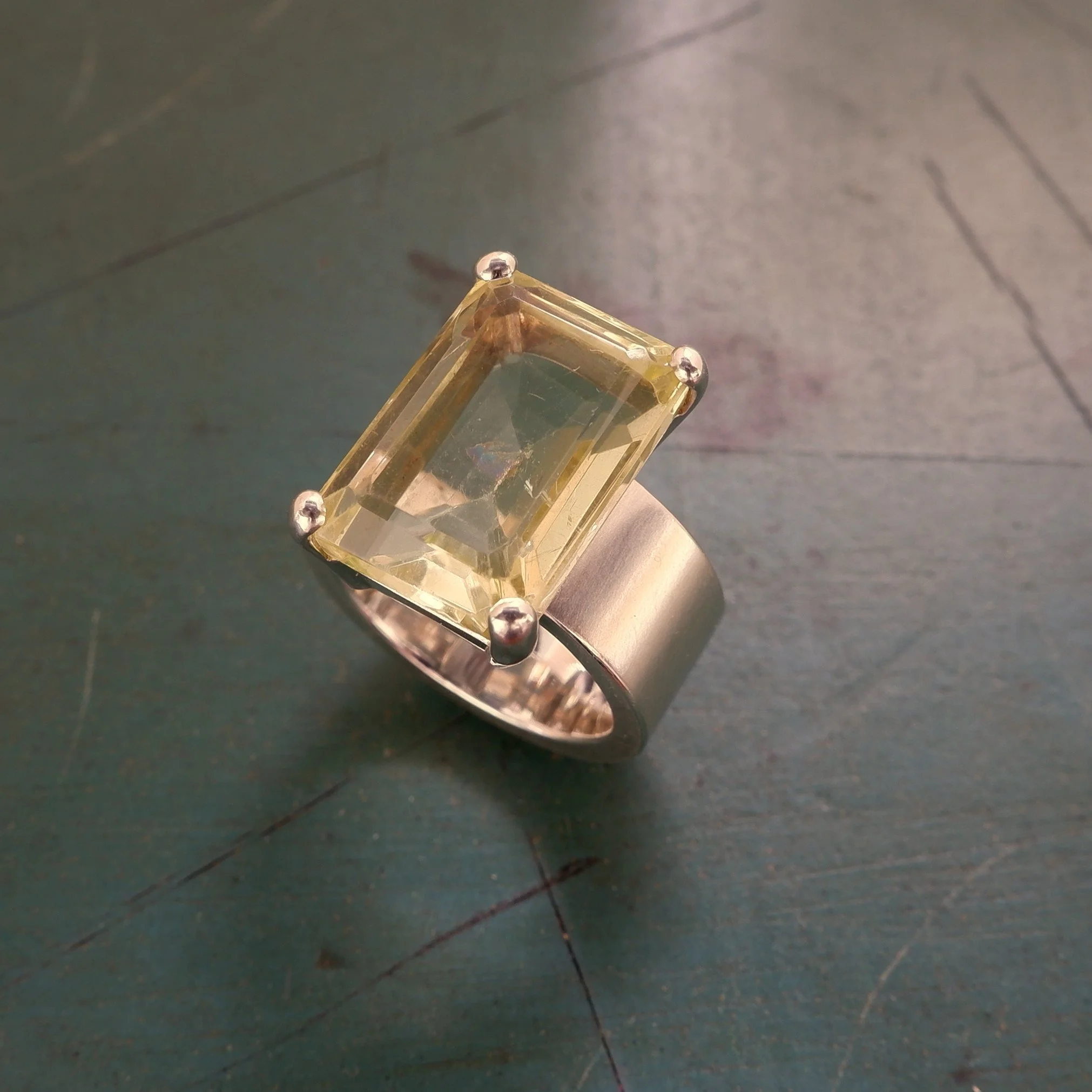 A new silver ring set with client's lemon quartz.