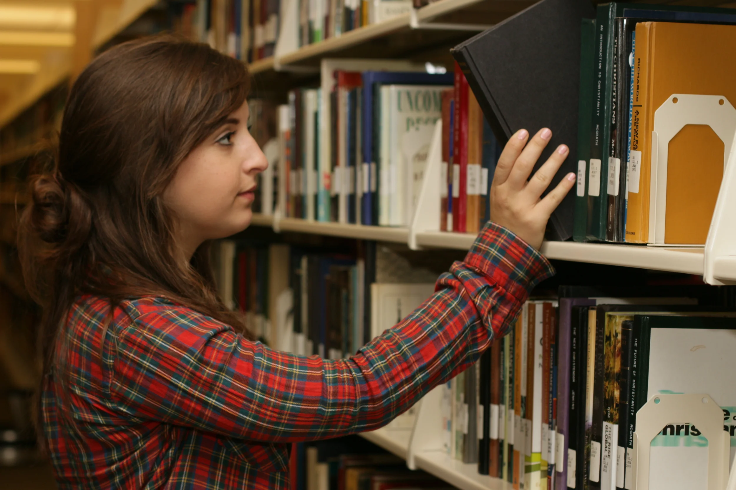  Camera Setup: I instructed her to take out the book from the shelves while I take photo.&nbsp; I used the hotshoe external flash and fired from the right side.  ---  Camera Setting:  • Aperture: f/4  • Shutter Speed: 1/100  • ISO: 200  • Lens: 50 mm