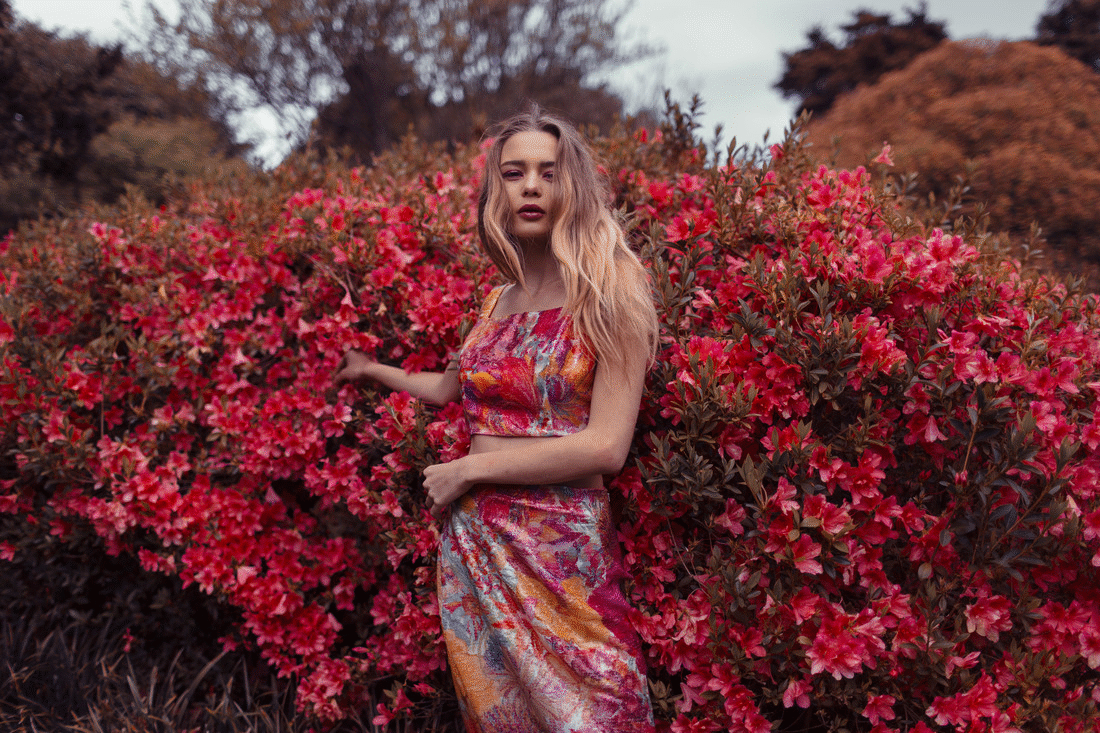  Fashion model moving amongst the pink flowers 