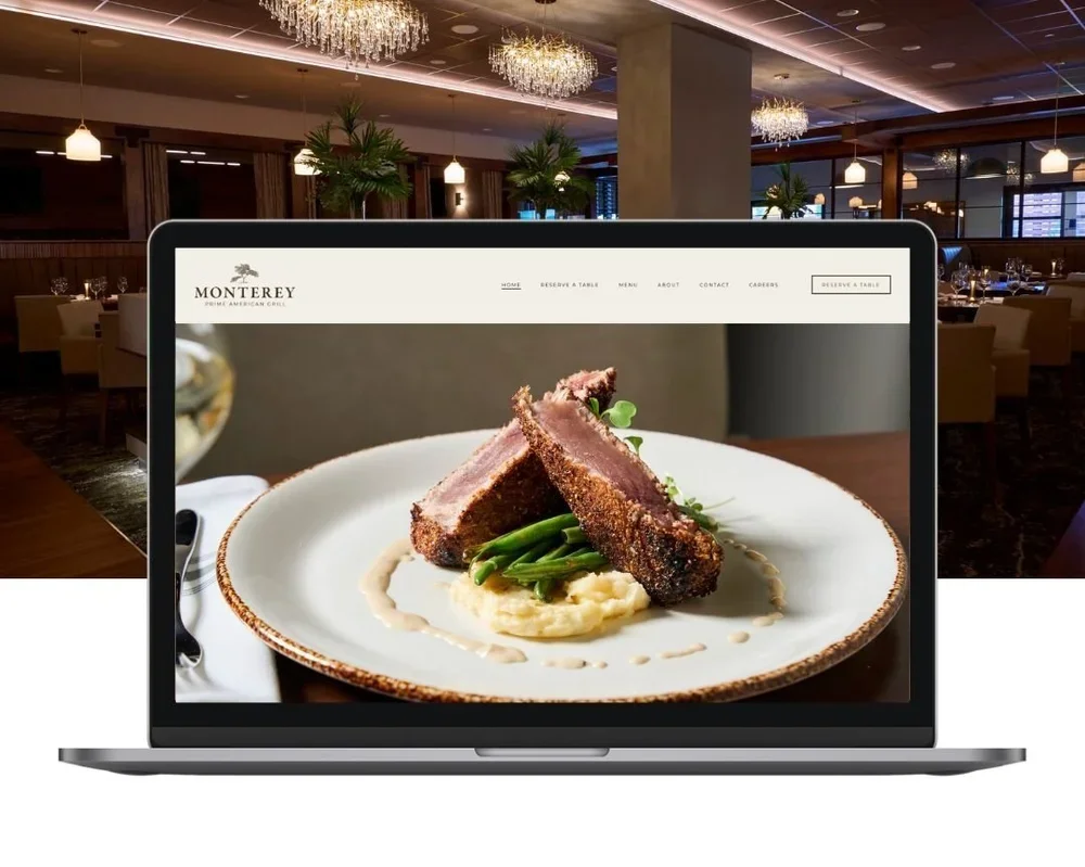 A laptop showing a restaurant website with a picture of a plated dish featuring two slices of beef Wellington, mashed potatoes, and green beans. The restaurant is named Monterey Prime American Grill.