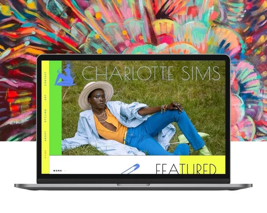 A laptop displaying a website featuring a photograph of a woman lying on grass, wearing a wide-brimmed hat, yellow top, blue jeans, and jewelry, with the name Charlotte Sims on the site.