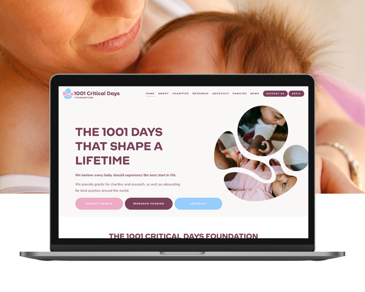 A laptop displaying the website for the 1001 Critical Days Foundation, with an image of a mother holding a baby in the background.