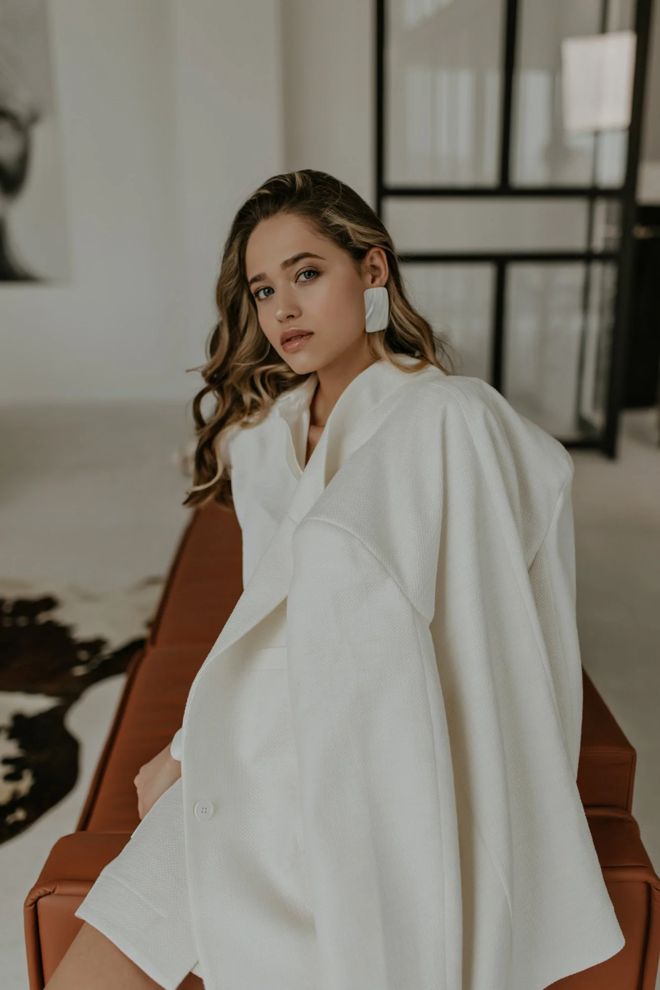 portrait-blonde-curly-lady-covers-her-body-with-oversized-white-stylish-jacket-attractive-woman-3.jpg