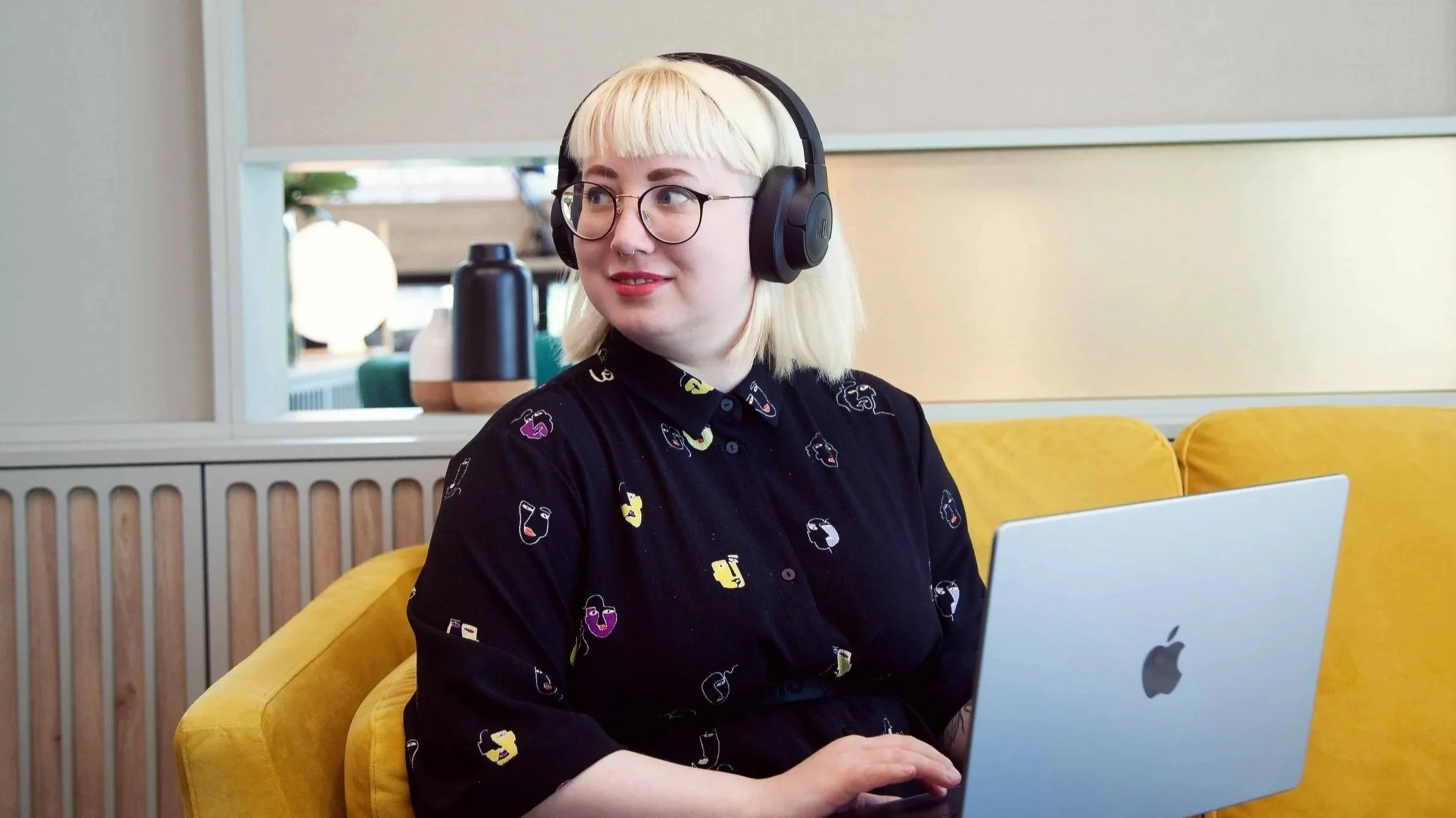 Creative business owner researching Squarespace 7.0 vs 7.1 on a MacBook.