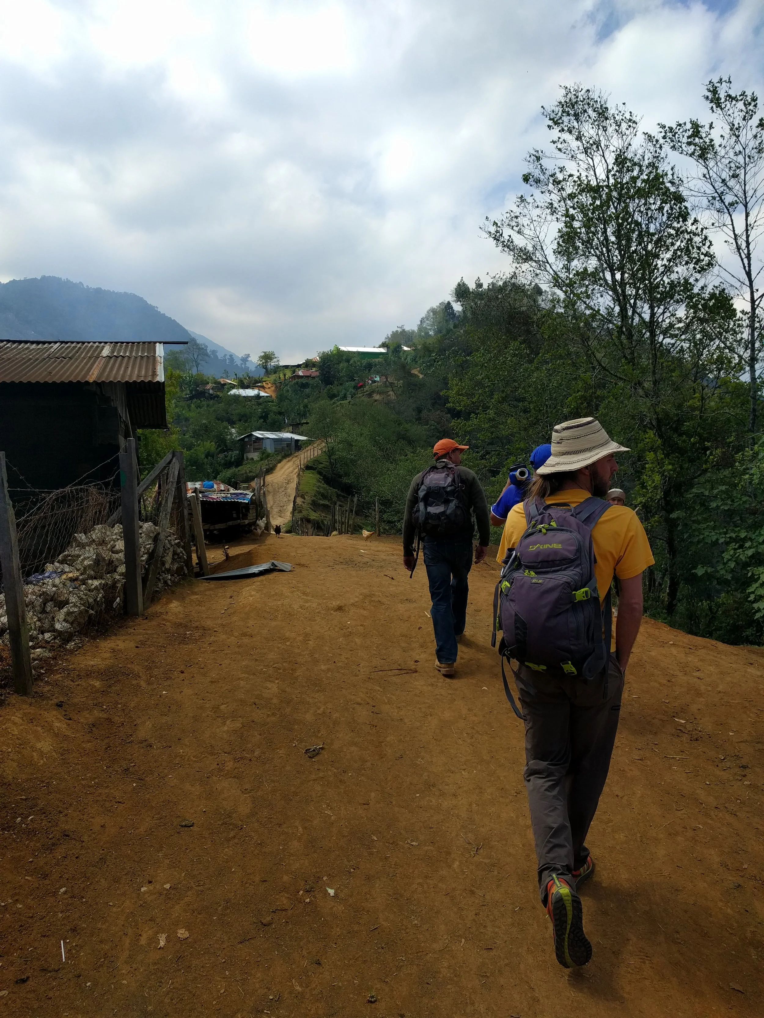 RMP member Dave Caley, Diego, and mason Christobal walking through Sumal Grande to see the progress of the construction.