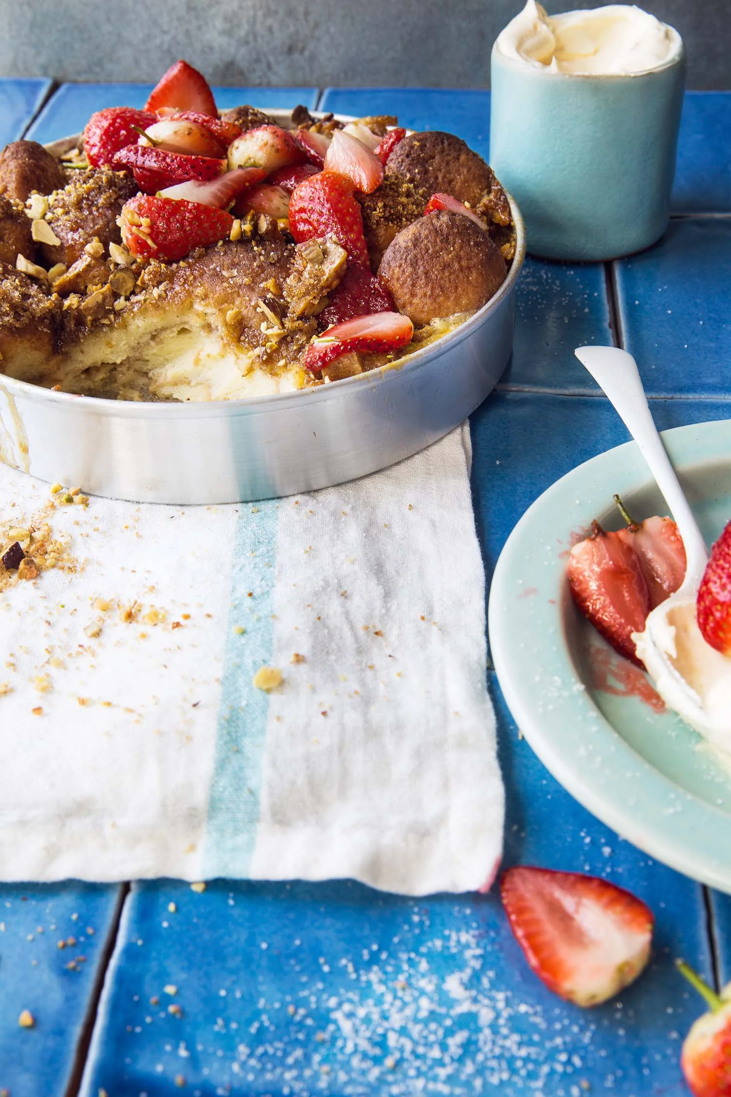 Doughnut bread and butter pudding with strawberries and almonds
