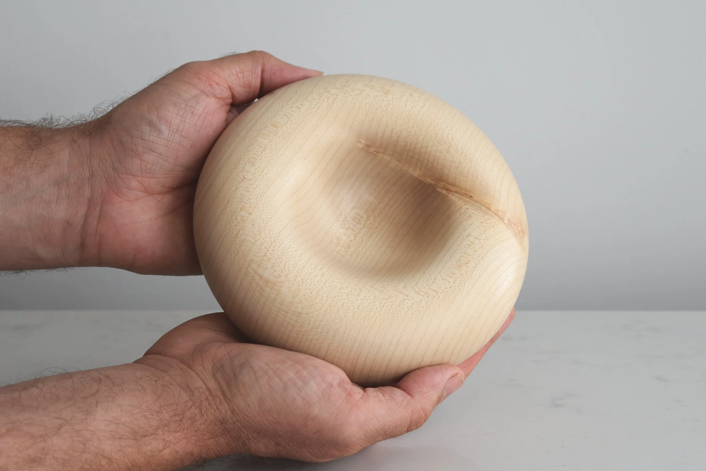 Deep Pillow in Sycamore, additional view with hands, handmade wooden homeware by Bird & Branch