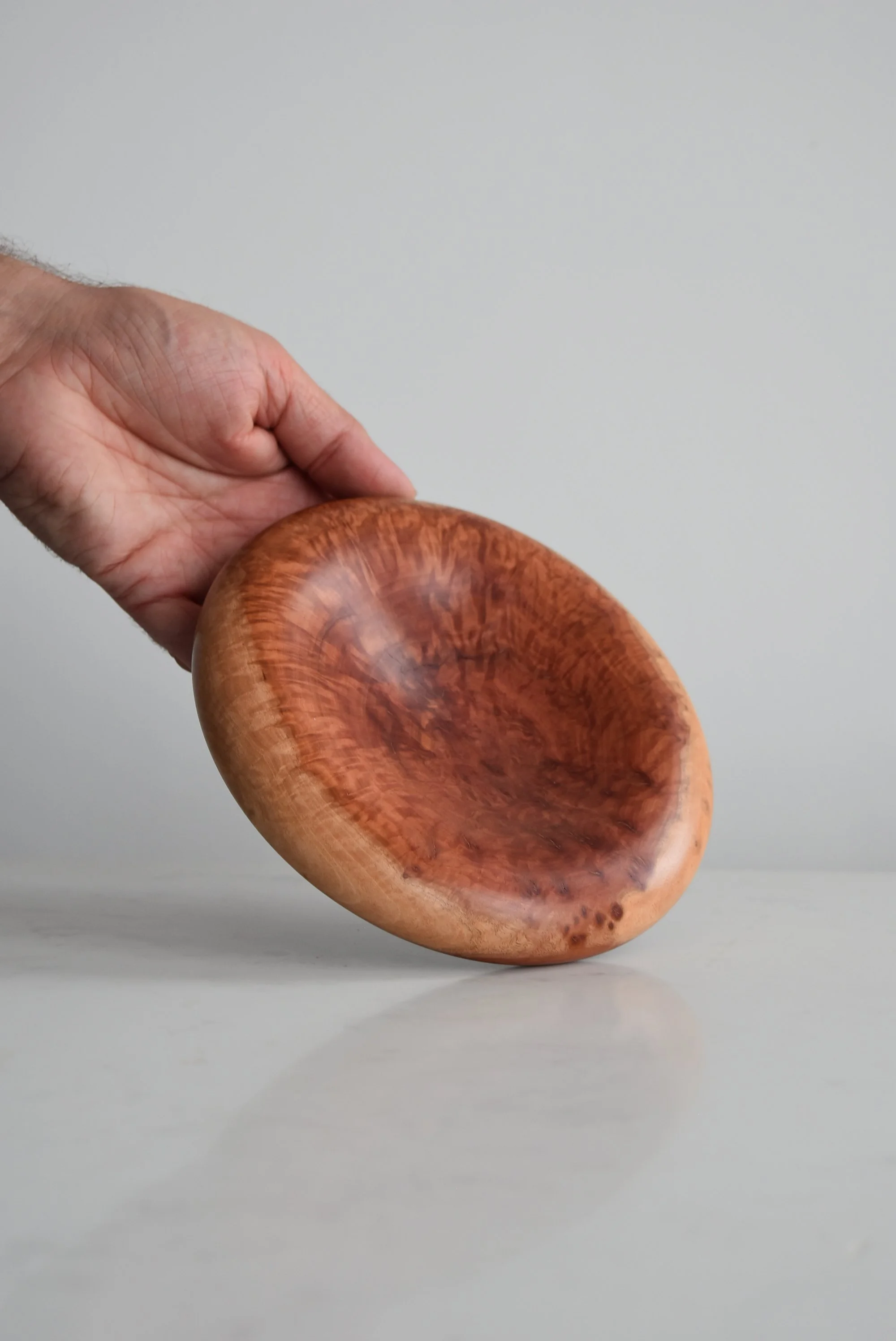 Flat Medium Pillow Plate in Red Mallee, additional view of product with hand, handmade wooden homeware by Bird & Branch