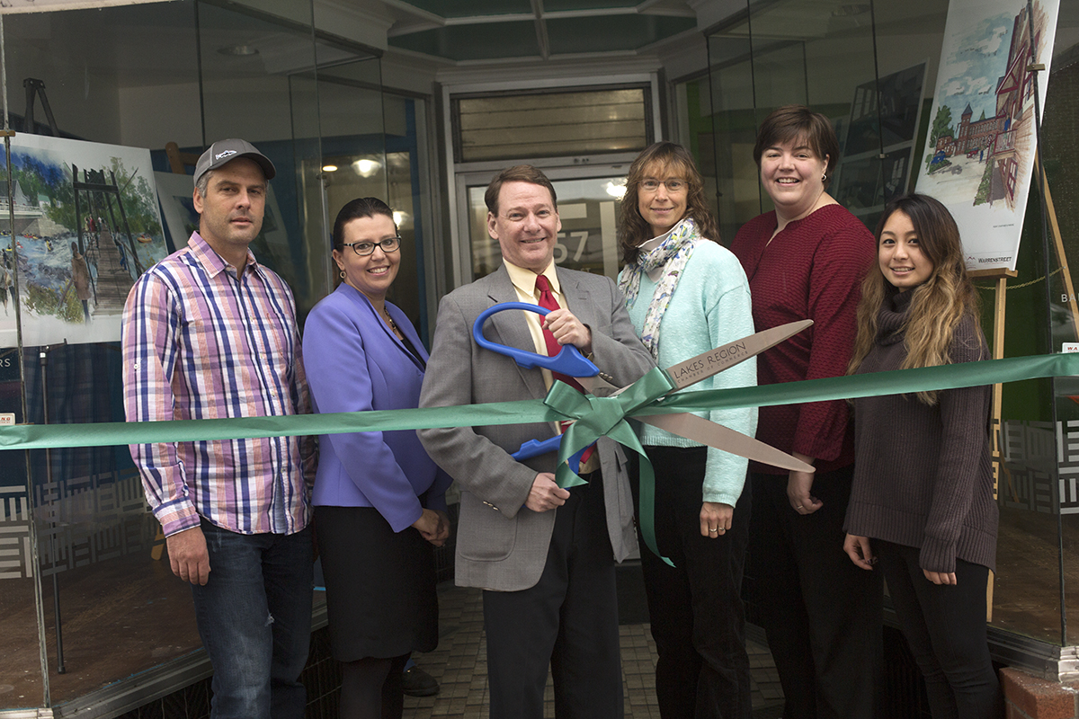 Executive Director of PermaCityLife Todd Workman, City Manager Elizabeth Dragon, Mayor Ken Merrifield, Assistant Professor of Environmental Studies and Director of Sustainability Jen White ’90, Colby-Sawyer President Susan D. Stuebner and Community Development Coordinator of PermaCityLife Jenisha Shrestha '14 gathered to cut the ribbon to the PermaCityLife storefront. Photo by Chris Kontoes