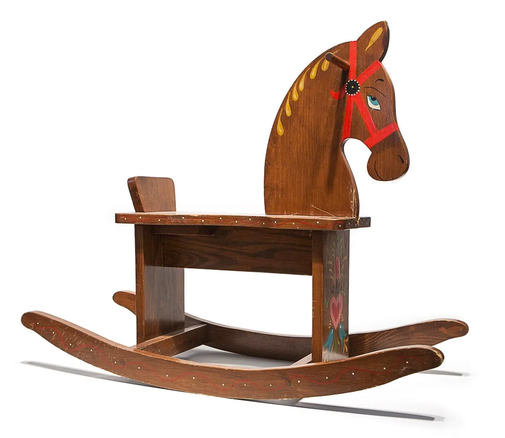 Built by grandpa Perry; painted by grandma Perry; a collaboration in the same year in which a bouncing baby boy named Mike Perry was born; the horse came to Brooklyn in pieces, but is now mended.