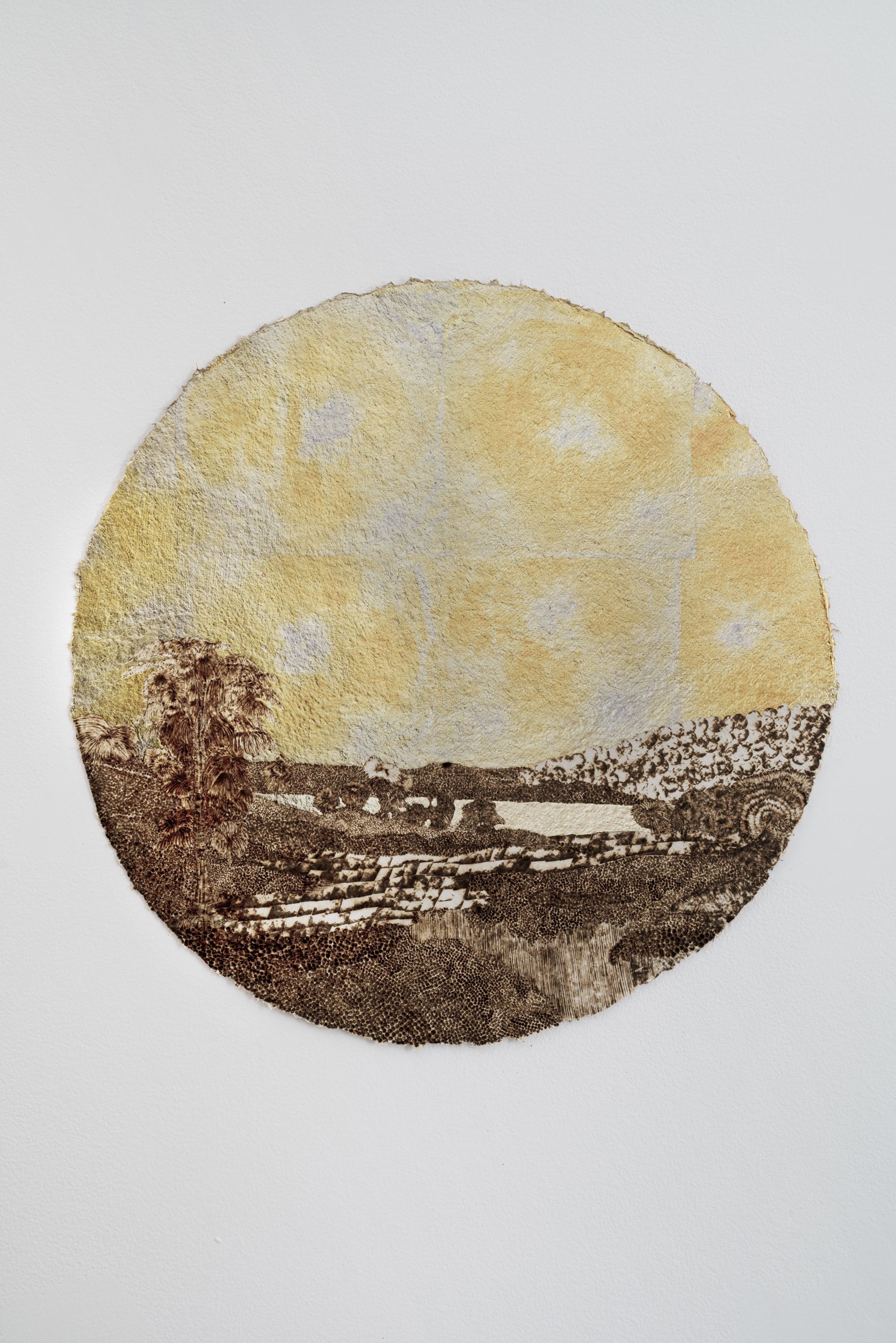   Landscape with Rainbow at Sunrise as things Emerge (for R. S. D.),  1859/2021, burned handmade paper with blue pencil, variegated metal and composition gold leaf, 16 inches in diameter 