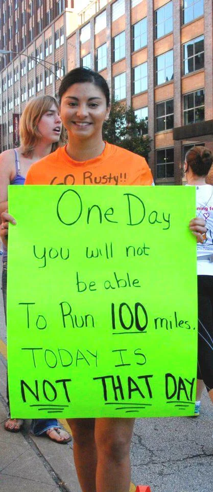 100 miles Anna holding sign.jpg