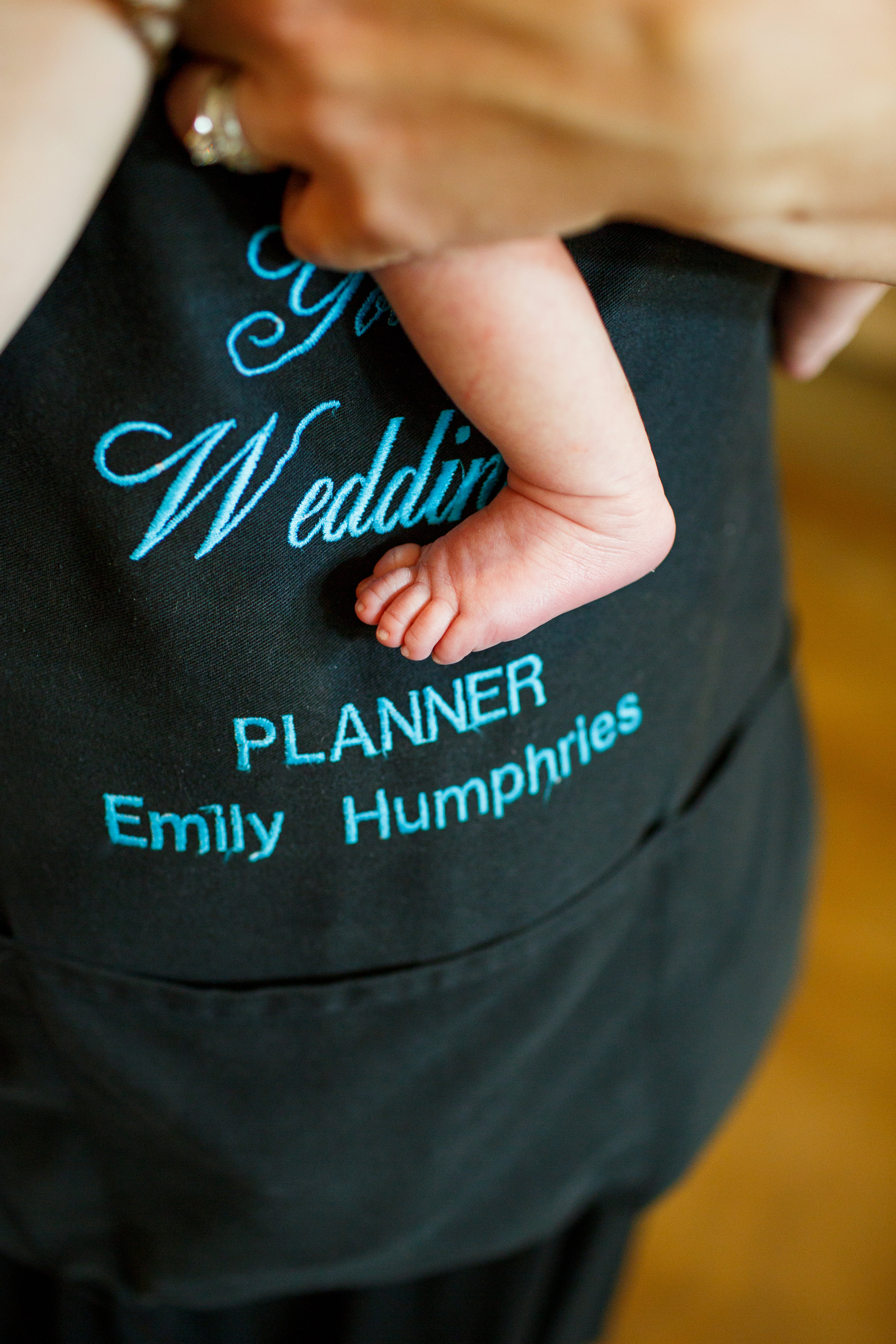 Photo of me working a wedding with my two week old son by Courtney Davidson Photography.