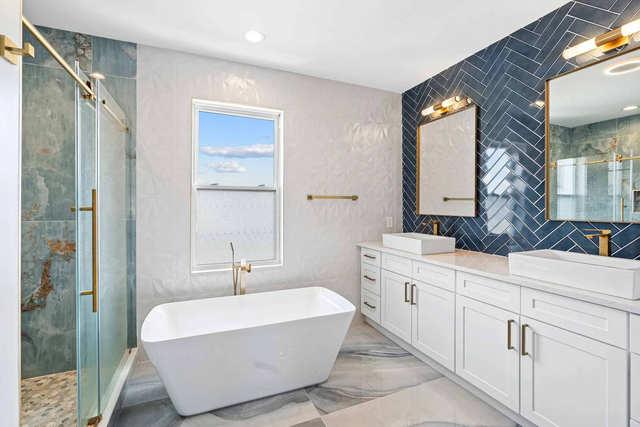 ✨JUST LISTED ✨ Wow! This is a big footprint and we think we just might move into that stunner of a primary bathroom! Let's not get ahead of ourselves and instead start on the first floor. Welcome in to the living room with painted exposed brick, a de