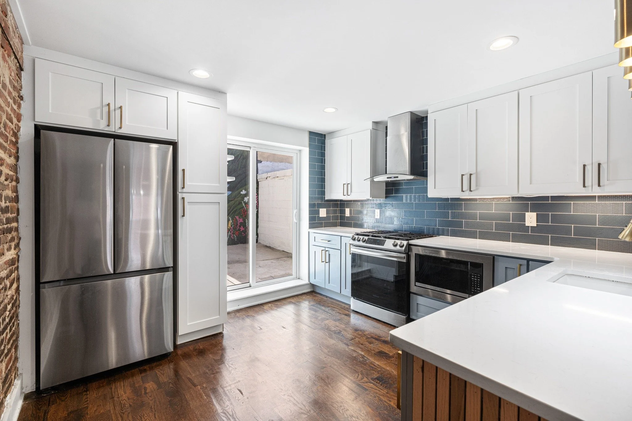 How is this stunner still available? If you are craving more space, this home has over 2,200 sqft of it! The wide living room has hardwood floors, painted brick and an electric fireplace to cozy around. Big bay windows let the light in at the front a