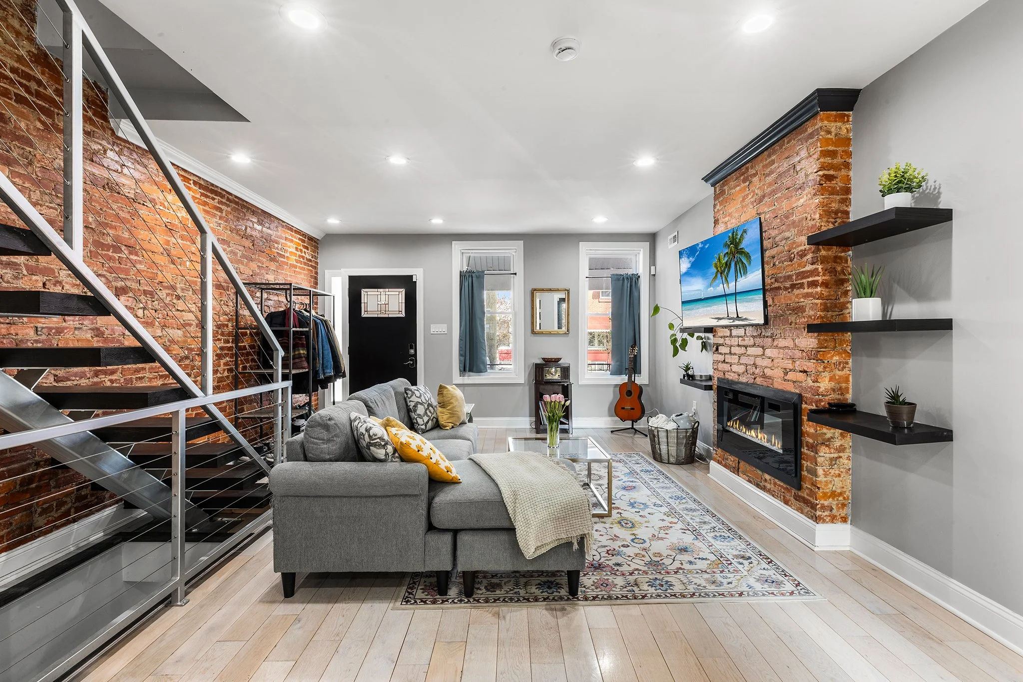 ✨JUST LISTED✨ Let's talk style first. Exposed brick, electric fireplace, tall ceilings with recessed lighting make the living room a place to entertain and get cozy on rainy days. The kitchen has a desirable extra long island and lots of storage- the