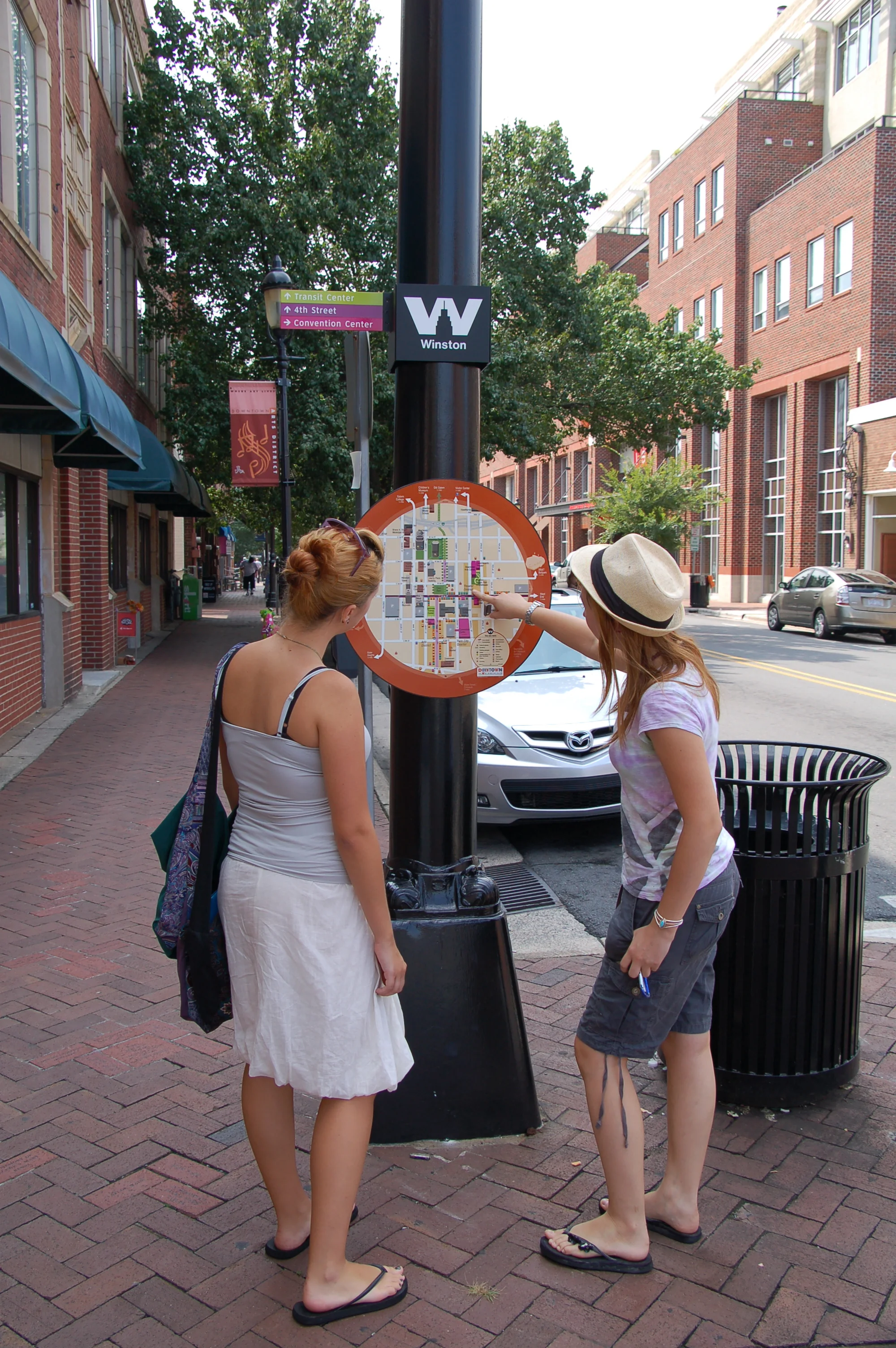 Passers-by checking out personal map station in Winston-Salem.