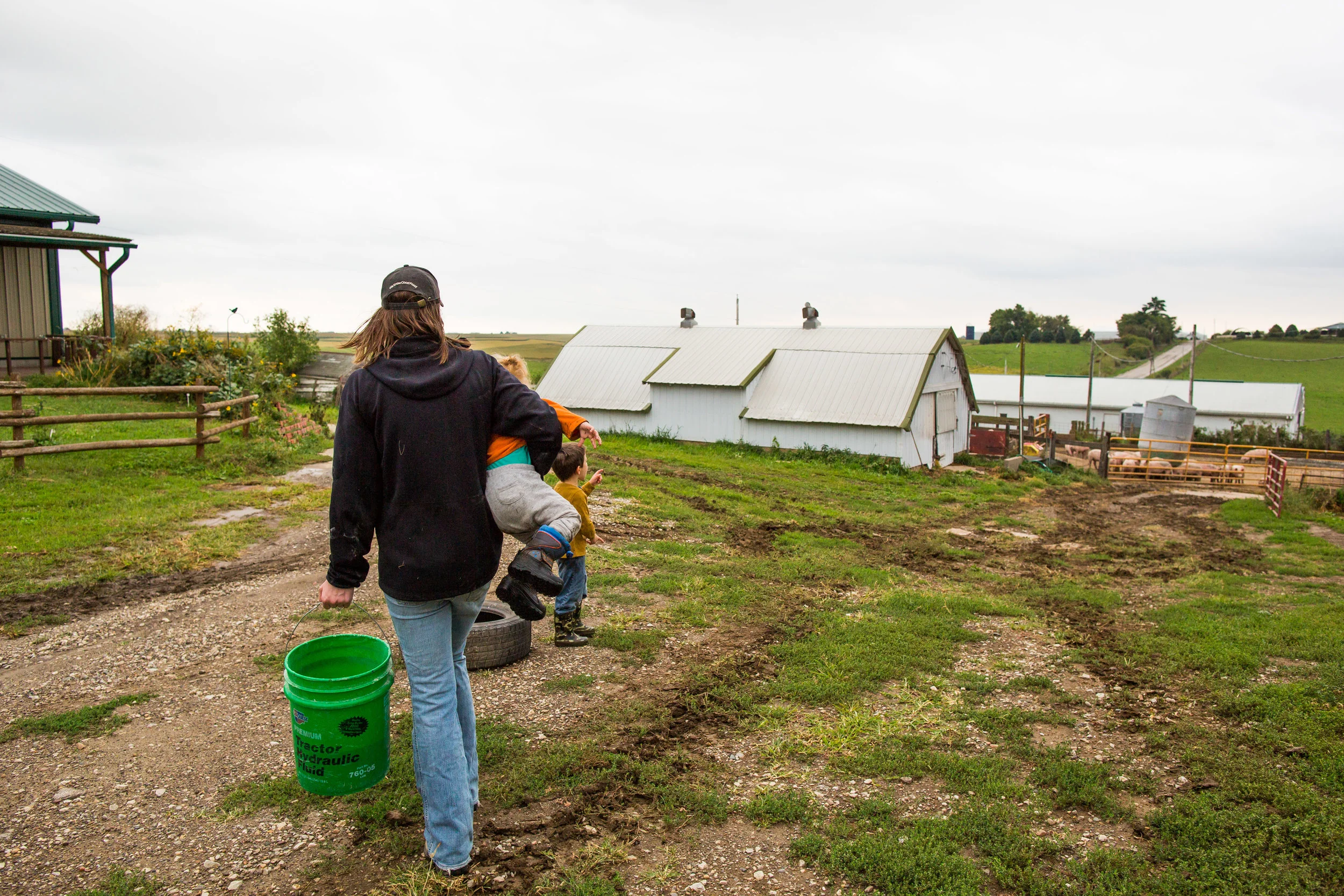 Hog feed in one hand, toddler in the other. The balance.
