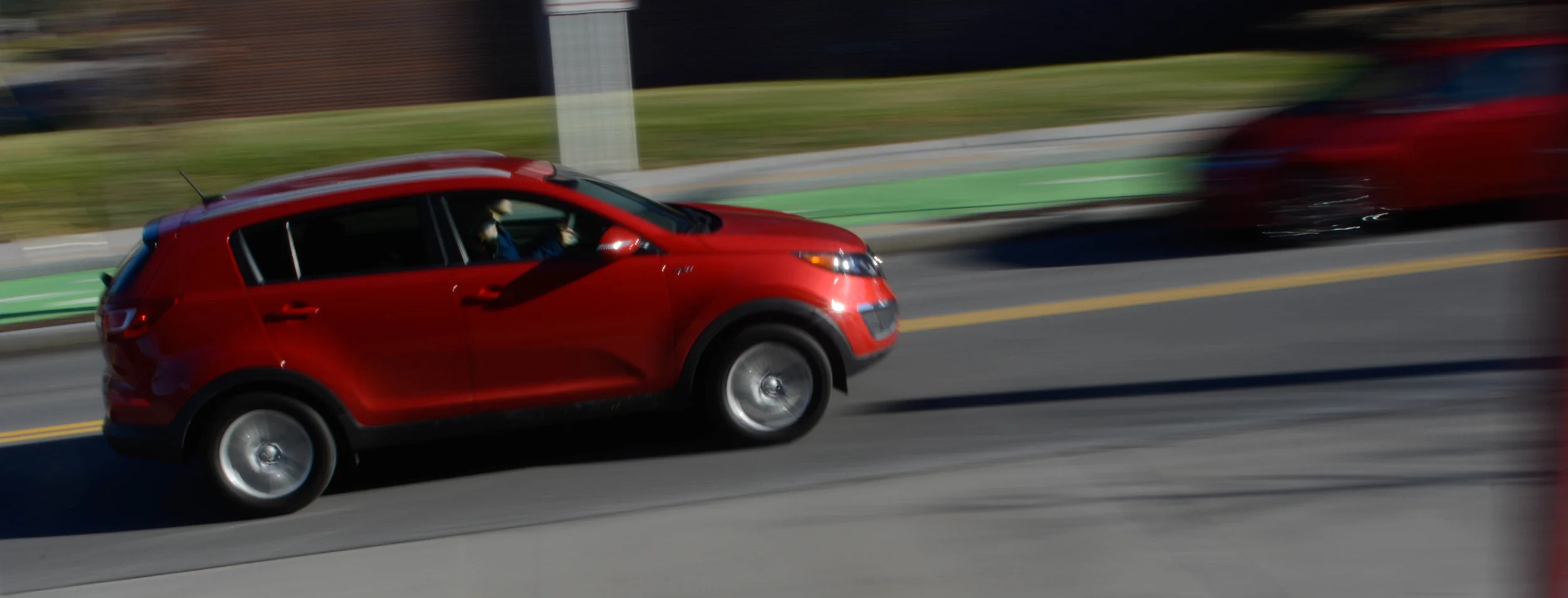  A very difficult photograph to take. This one is called a pan shot and as you can see, the background of a moving object is blurred while the moving object is not. The camera has to move as fast as the car in this case to create the desired effect.&