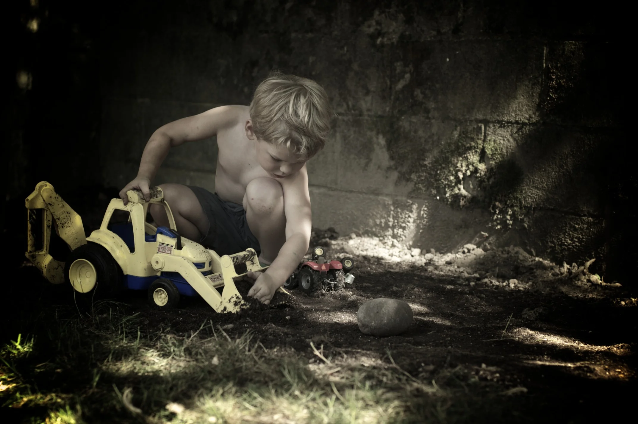 a boy, a truck, and dirt
