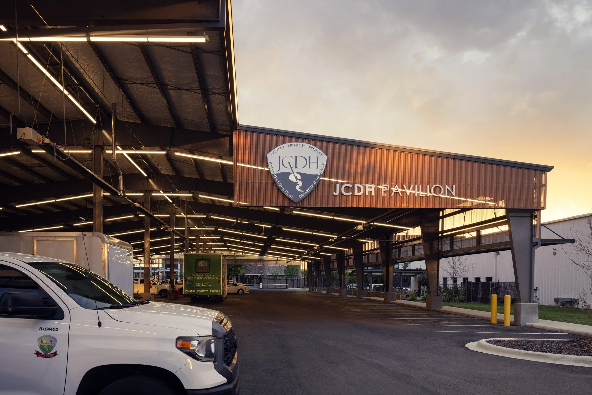 An open-air structure designed to support drive-through healthcare screenings and vaccinations&mdash;clad in copper-toned, perforated panels, the pavilion balances functionality with symbolic transparency, underscoring Jefferson County Department of 