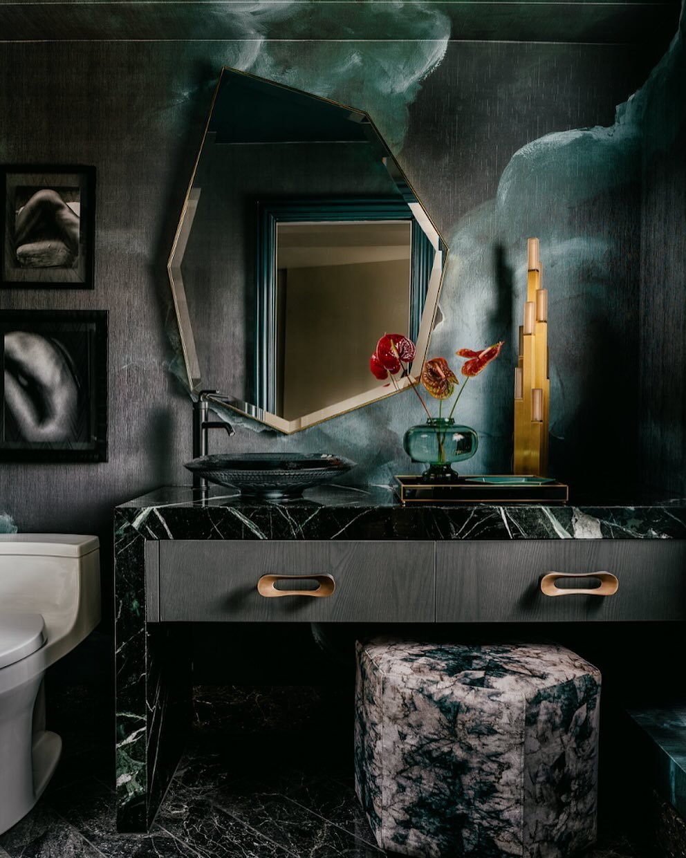 &ldquo;Every room begins with a pilot, and for this bathroom we started with the deep green clouds in the wall covering.&rdquo; The deep green of the Verdi Alpi  marble on the vanity and the organic movement in the wallpaper create richly layered spa