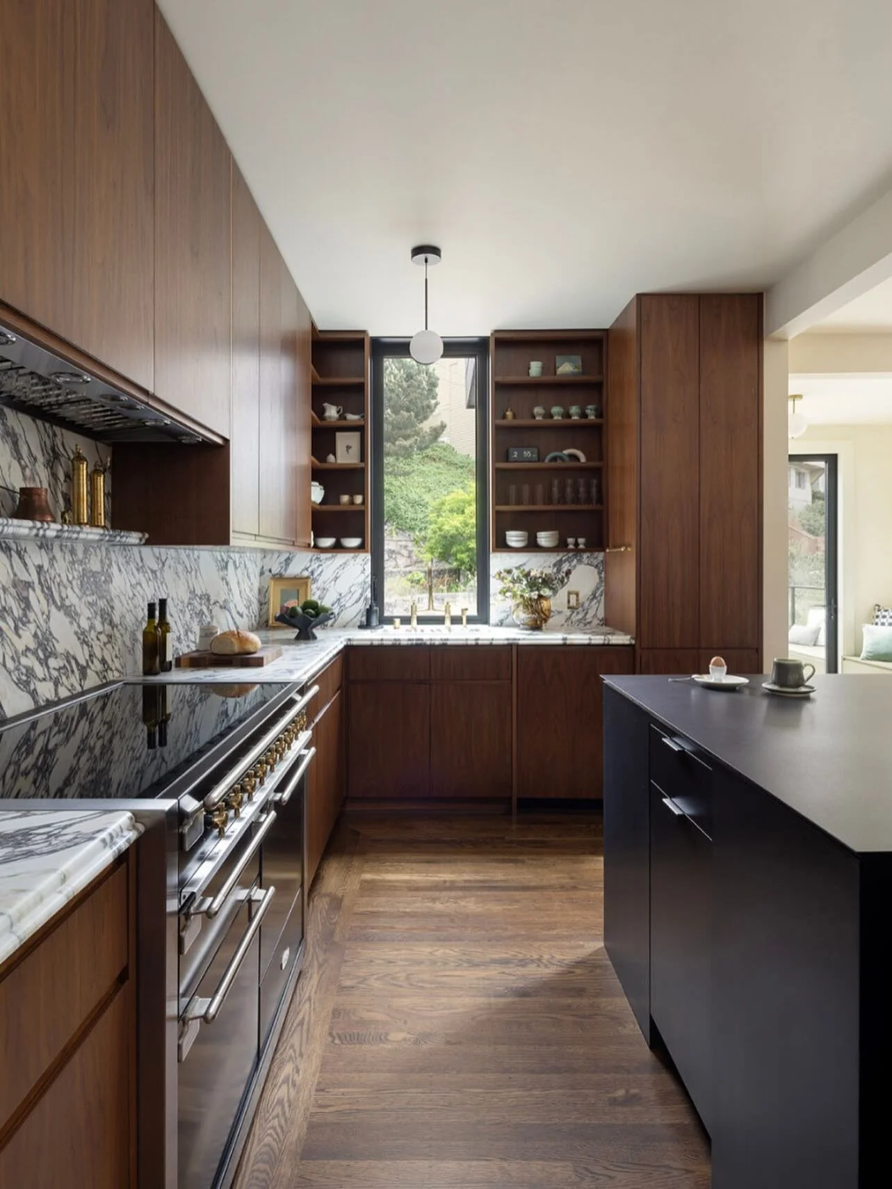 This kitchen embodies warmth, craftsmanship, timeless design. Set within a San Francisco Edwardian, this space pairs rich walnut cabinetry, dramatic marble surfaces, and refined detailing to create a distinctly personal and enduringly elegant residen