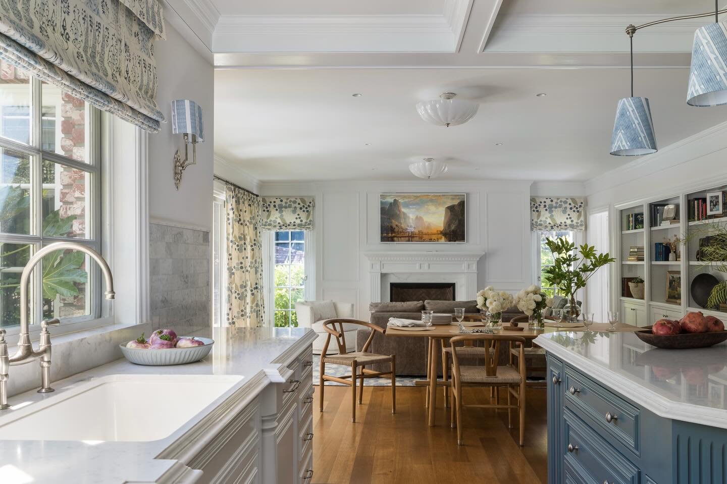 Soft blues, warm wood tones, and layered textures bring a sense of refinement and ease to this kitchen and dining space, creating an atmosphere that feels both welcoming and thoughtfully composed. It is the kind of place where everyday moments natura
