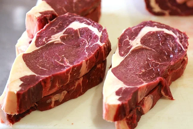 EAT WELL Local grass-fed beef from PC Cattle Co. shows off a dark wine color and gorgeous marbling. PHOTO BY DYLAN HONEA-BAUMANN