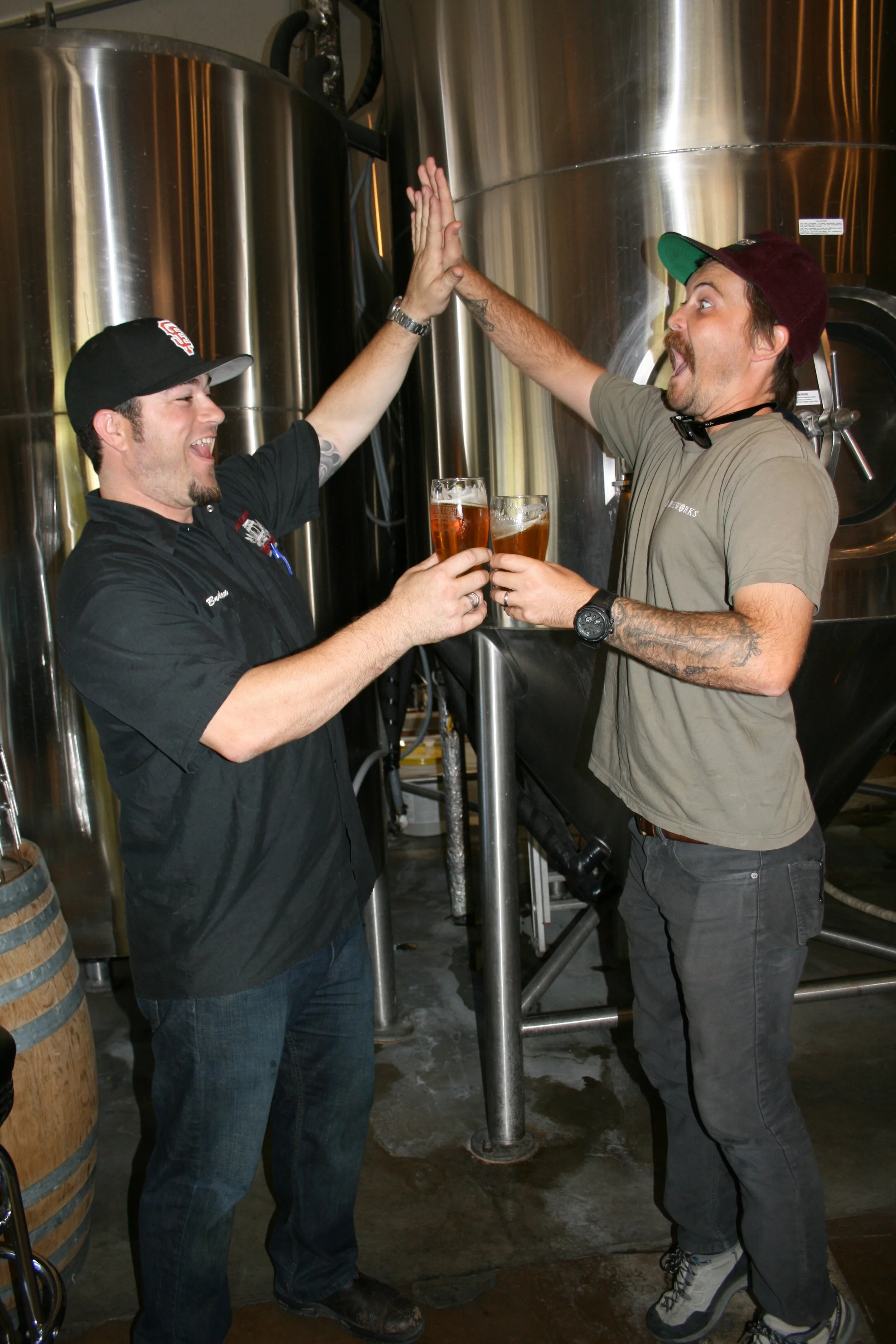 BEER FIVE Central Coast Brewing Co. Head Brewer Brendan Gough (left) and Libertine Brewing Co. Co-Owner/Brewmaster Tyler Clark go for a “high-five/beer-five.”