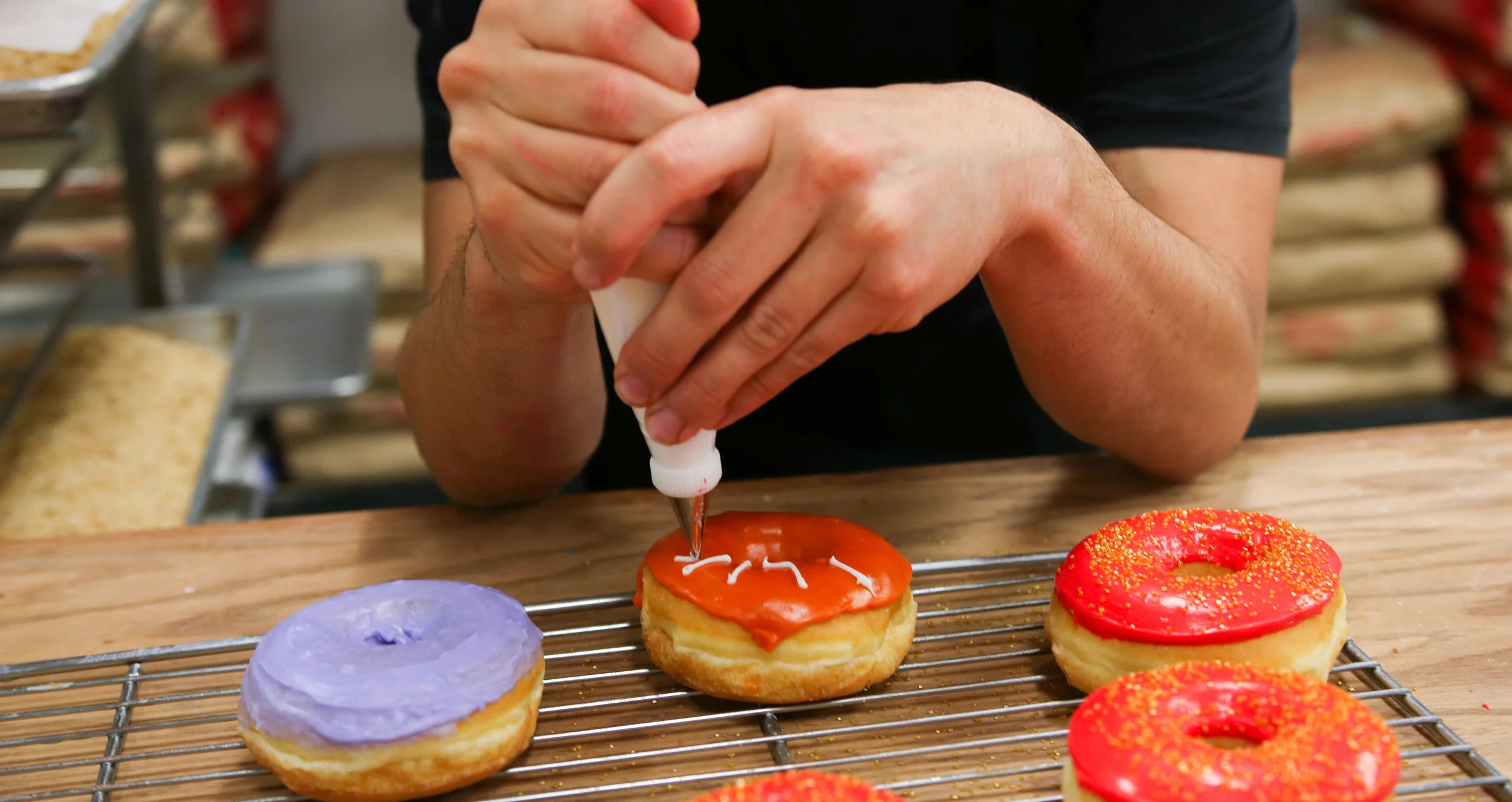 DOLLARS TO DONUTS SloDoCo Creative Baker Kenny Hall rises while most of us are deep in slumber to transform rounds of fried dough into literal galaxies of flavor.