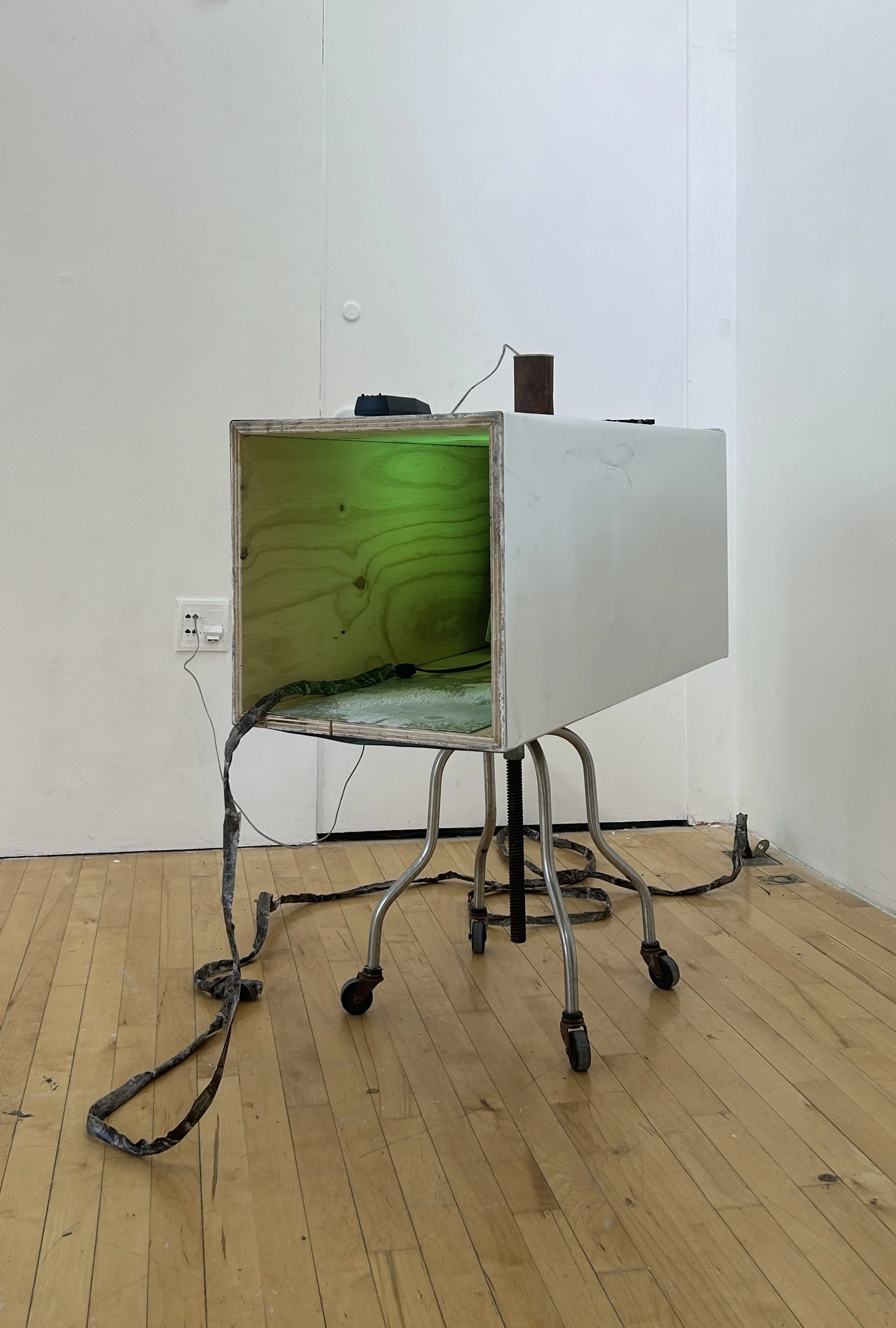 Radiant Corrosion, Refracted Horizontal Shift, 2026, tin can, phone cord, mirror film, duct tape, pedestal, stool, salt, aluminum, lamp, a/c fan, hard drive, EMF magnetic field ghost detector