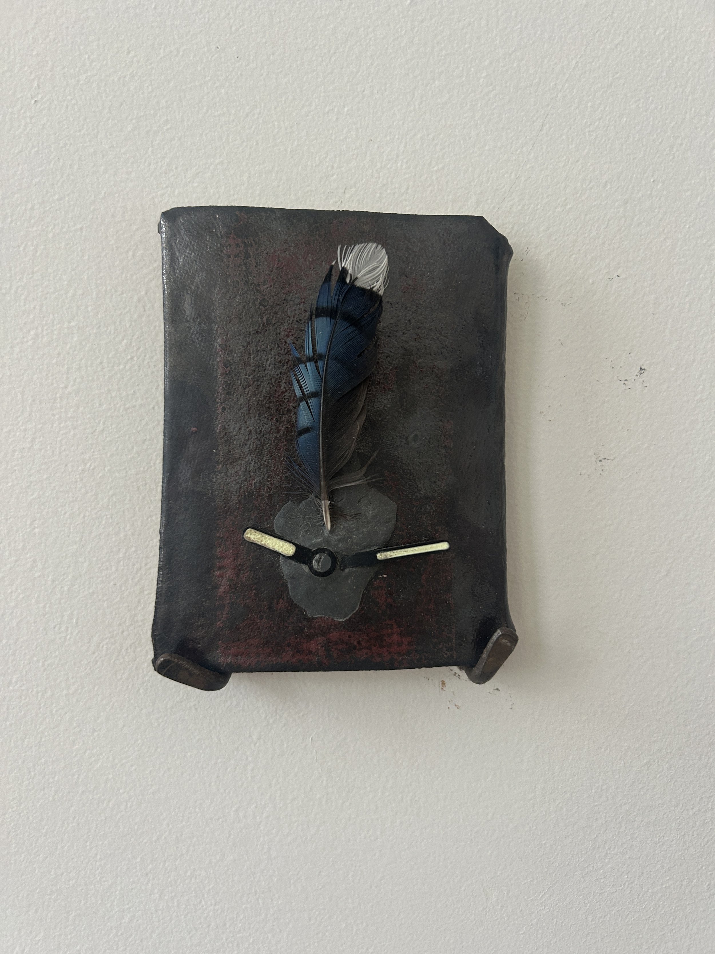 Clock, 2026, blue jay feather, clock hands, steel reinforced resin, glazed fired ceramic