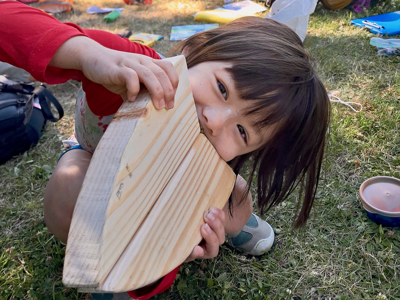child with wooden bird beak