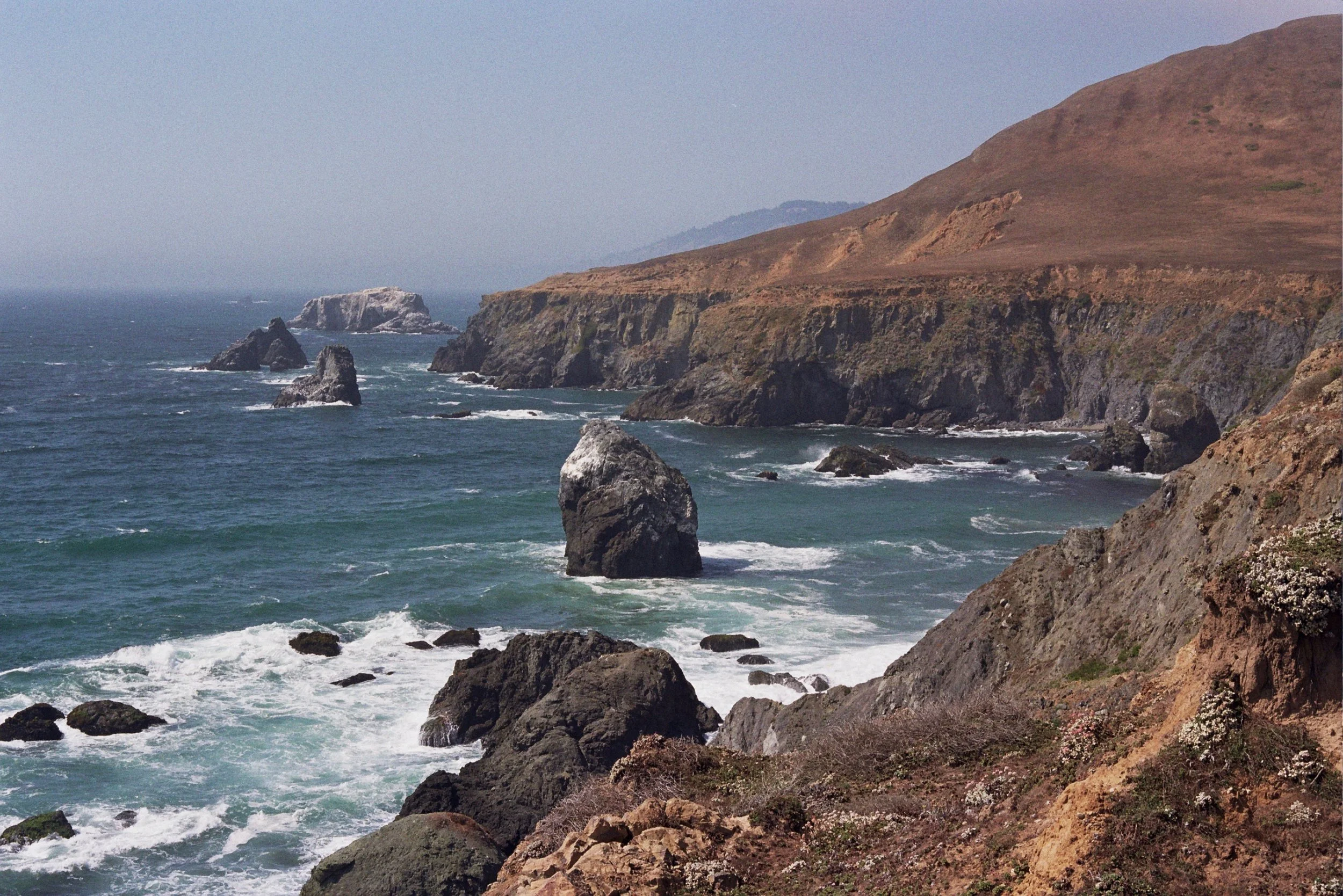 The trail winds close to the cliffs over the Pacific.