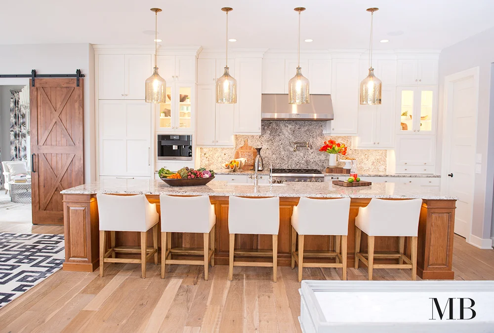 Warmth, style and functionality were top on the list for this kitchen. Integrated appliances keep the design cohesive and the symmetry of the cabinetry keep it feeling orderly. Beautiful finishes give this space a transitional aesthetic.