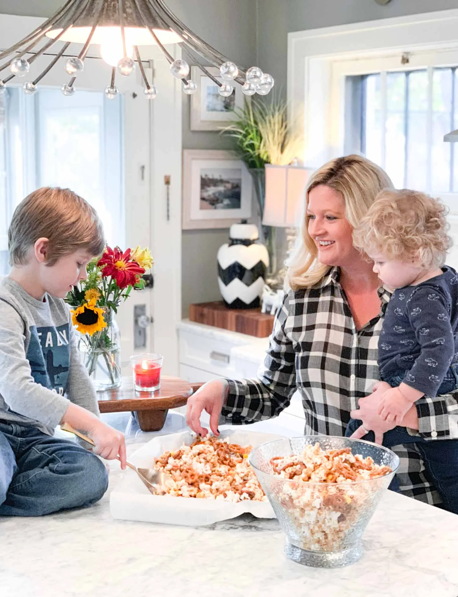 This week we made a candy coated popcorn and pretzel treat together. Having a large island really does make a difference in how our family uses a kitchen.