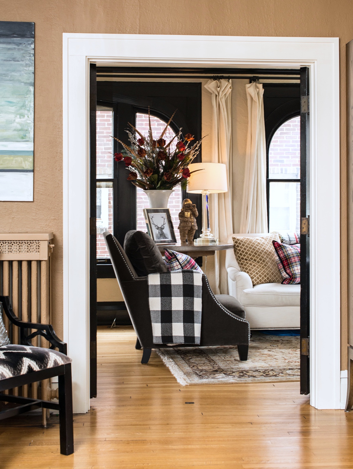 Incorporating plaids and buffalo check fabrics gives the more formal space a cozier feeling.