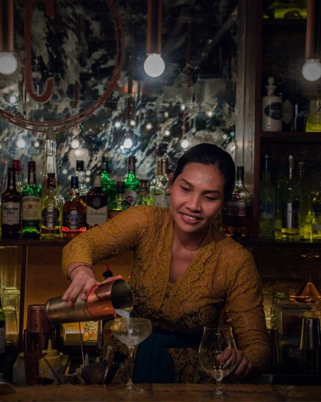 bartender at copper ubud pouring delicious cocktail