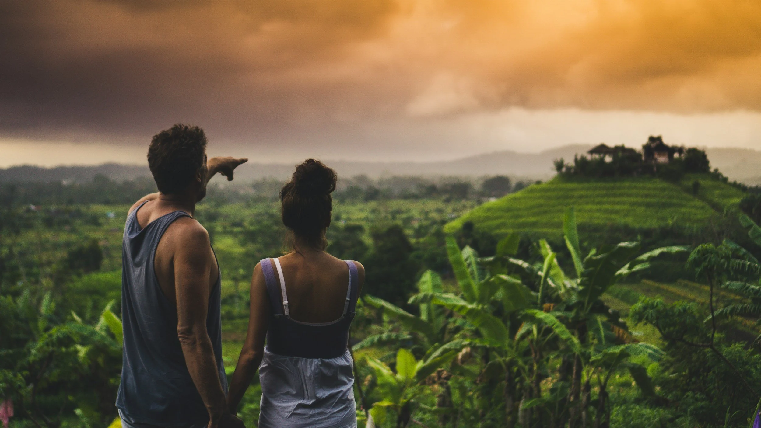 a couple hiking in bali overlooking rice terraces