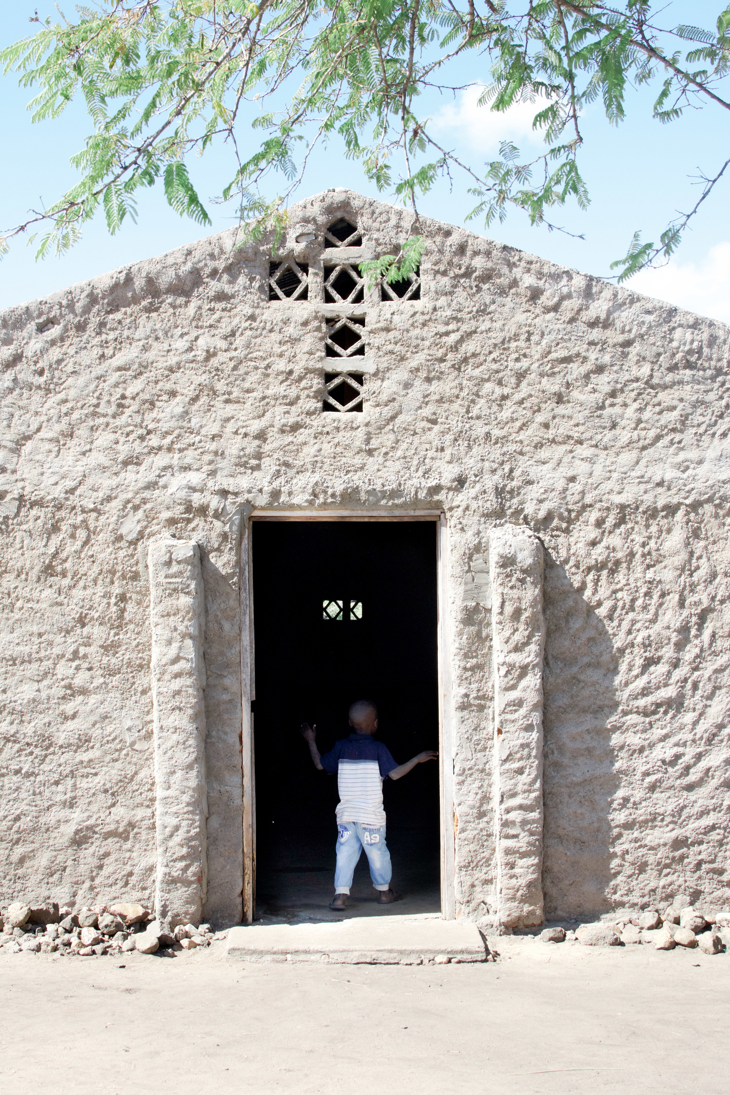 A young boy looks into the church building of St. Matthews Lutheran Church in Kapesseni. 