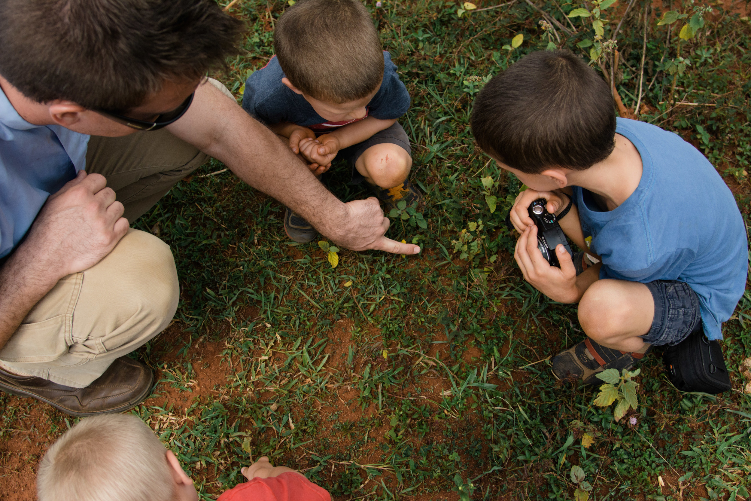 Rev. Shauen Trump showing his boys the local flora and fauna.
